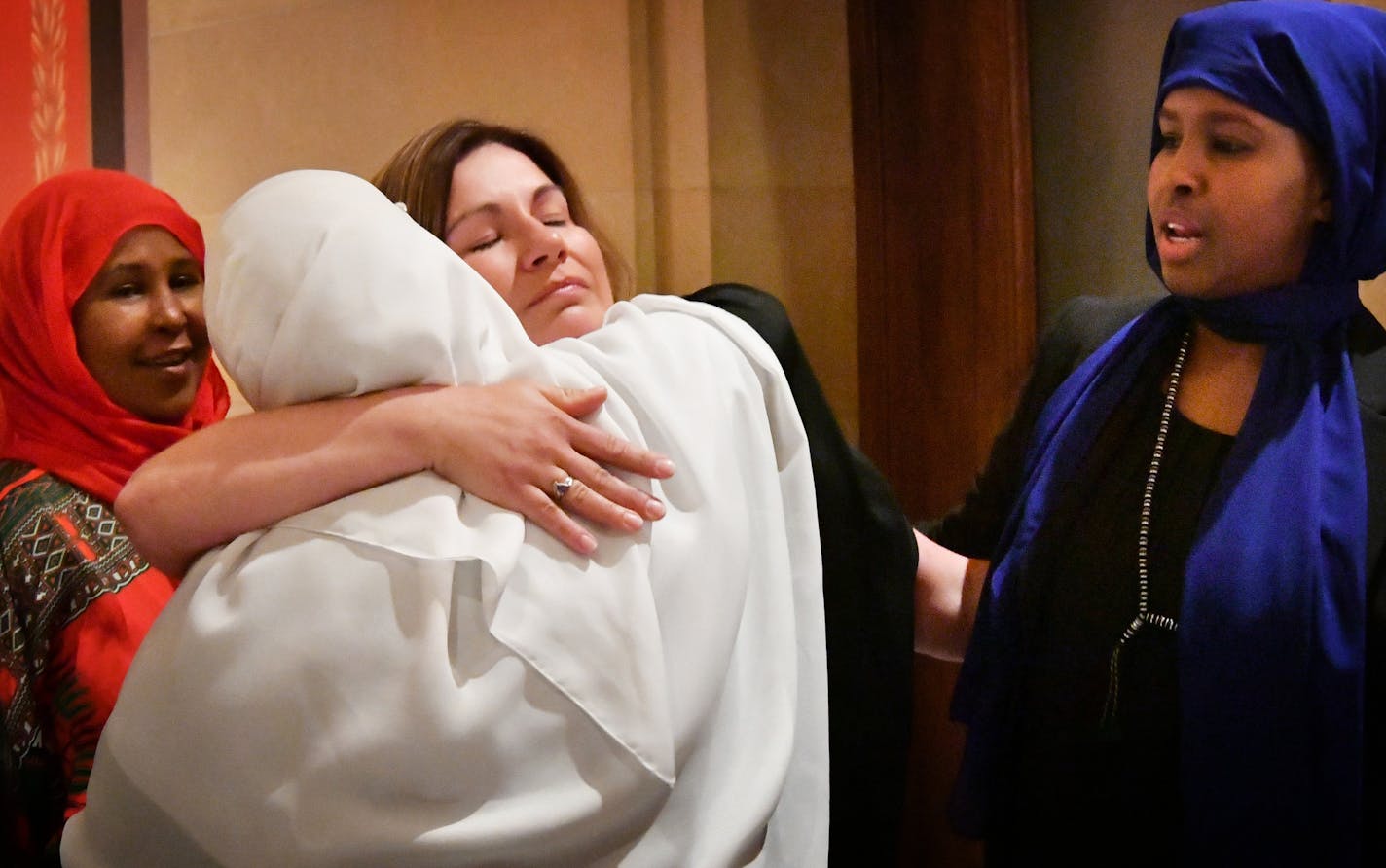 Rep. Mary Franson hugged survivors of female genital mutilation who came forward to testify in support of the bill. From left, Fadumo Abdinur, Waris Mohamud and Farhio Khalif.