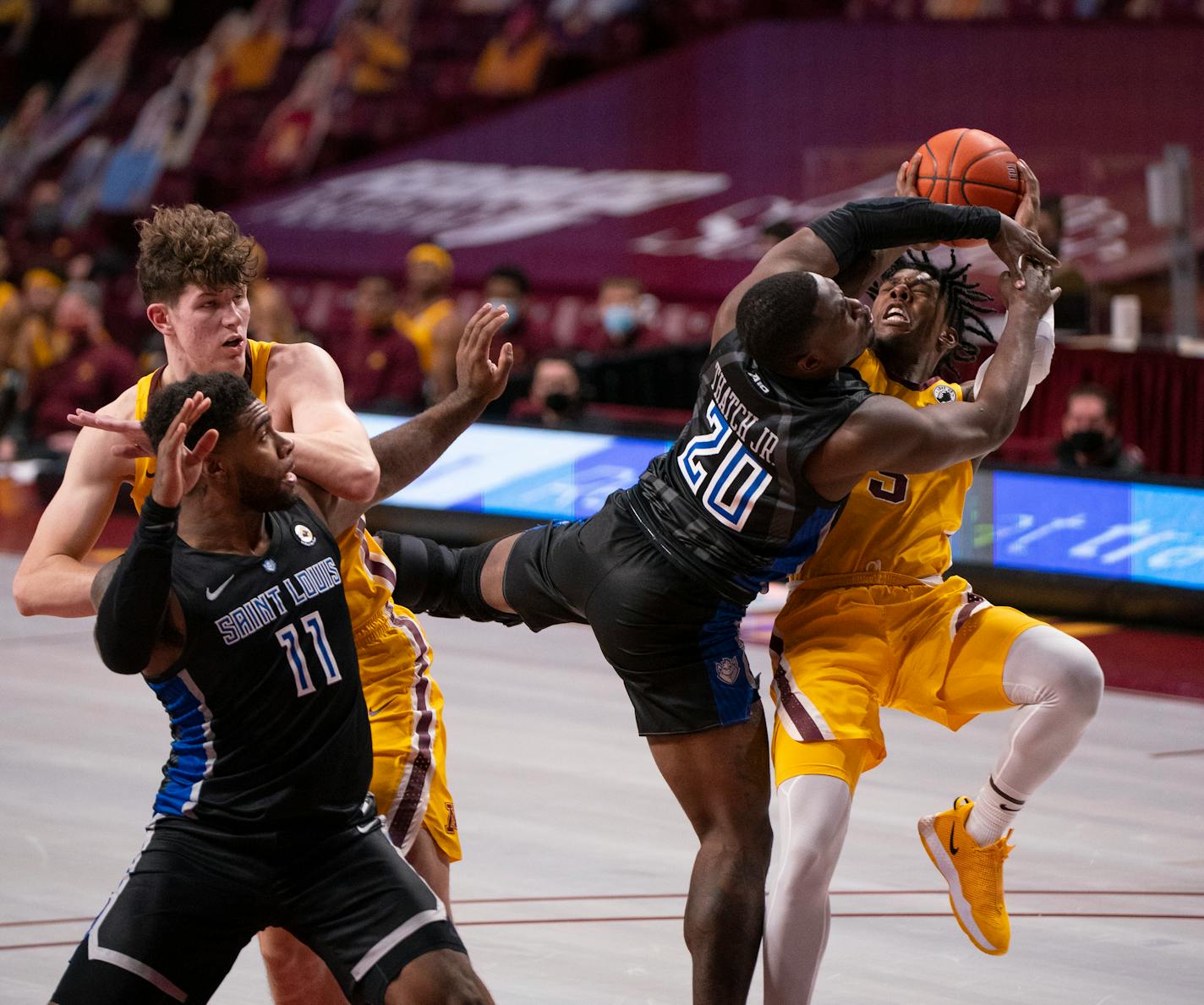 Gophers guard Marcus Carr tried to get a first half shot off with St. Louis guard Fred Thatch Jr. draped over him.