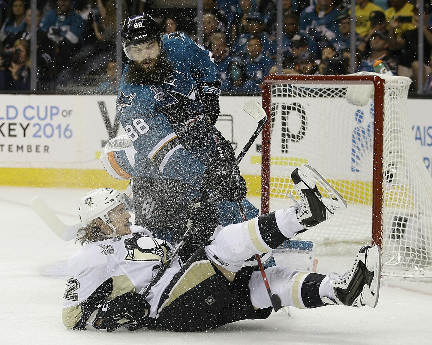 Pittsburgh Penguins left wing Carl Hagelin, from Sweden, bottom, falls in front of San Jose Sharks defenseman Brent Burns (88) during the first period of Game 6 of the NHL hockey Stanley Cup Finals in San Jose, Calif., Sunday, June 12, 2016. (AP Photo/Marcio Jose Sanchez)