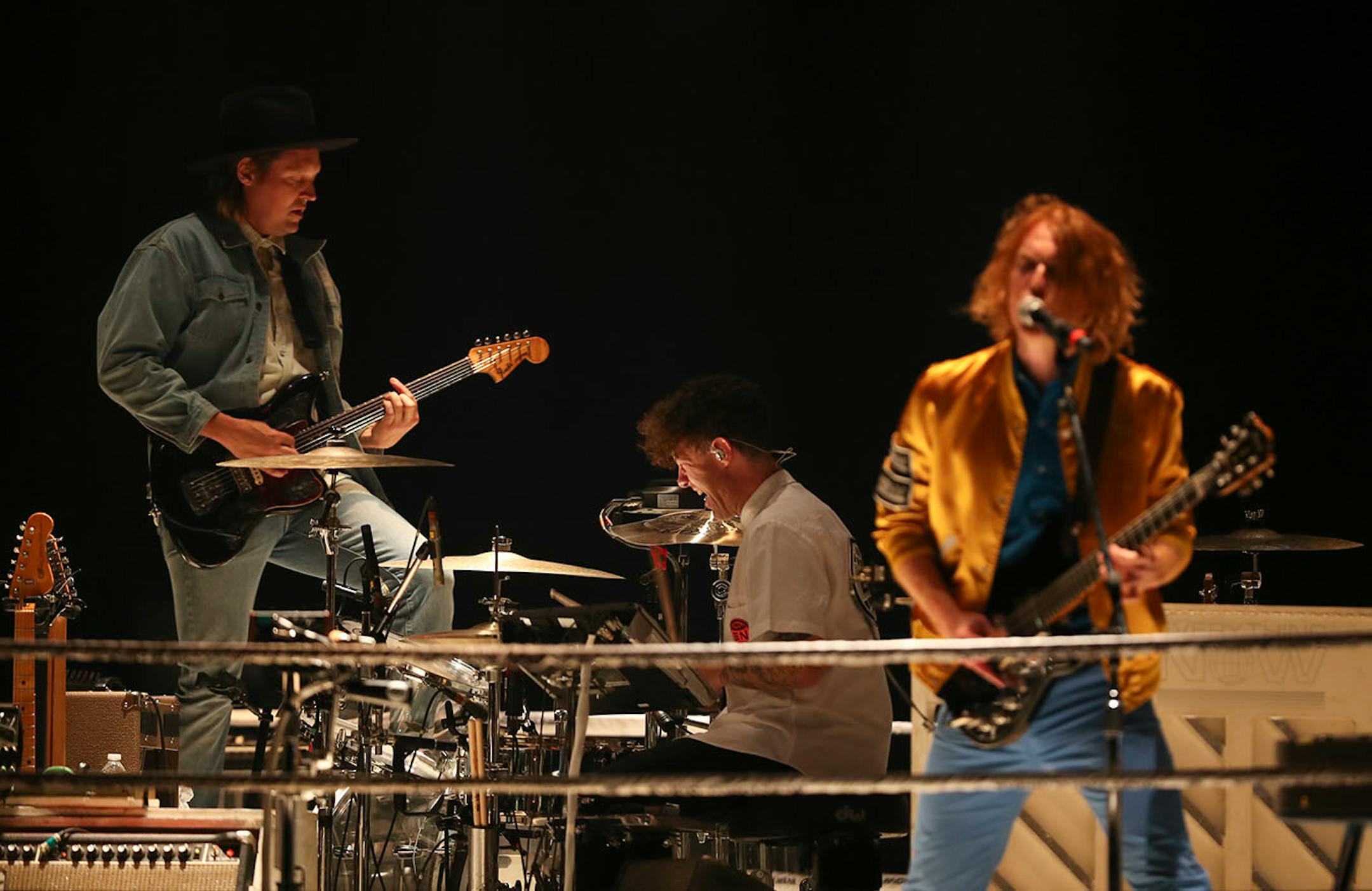 Win Butler, Jeremy Gara, and Richard Reed Parry, from left, of Arcade Fire during their show at Xcel Energy Center in St. Paul Sunday night.