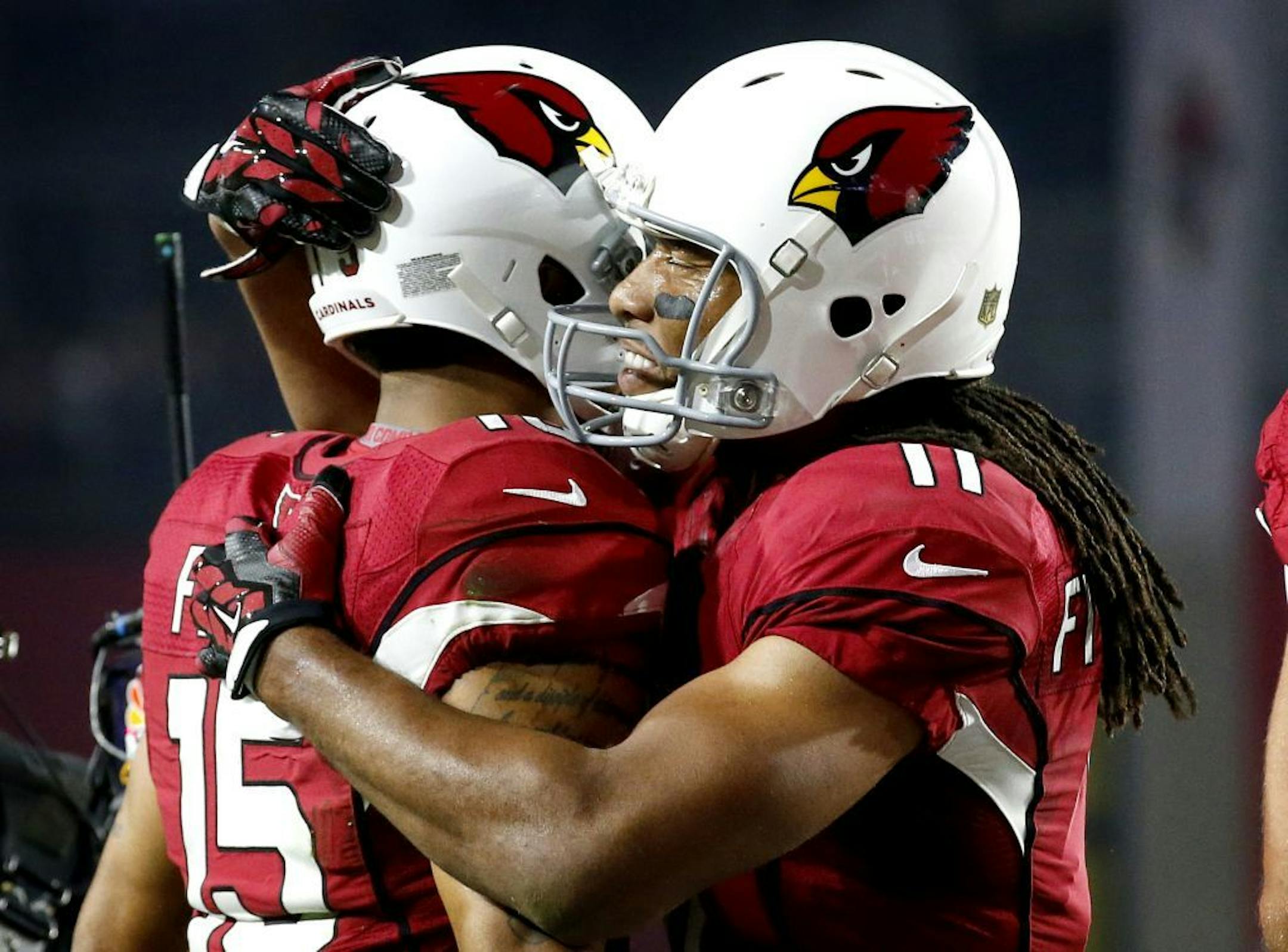 Cardinals wide receiver Michael Floyd (15) celebrated his touchdown catch with teammate Larry Fitzgerald Jr. during the first half of an NFL divisional playoff football game against the Green Bay Packers on Saturday.