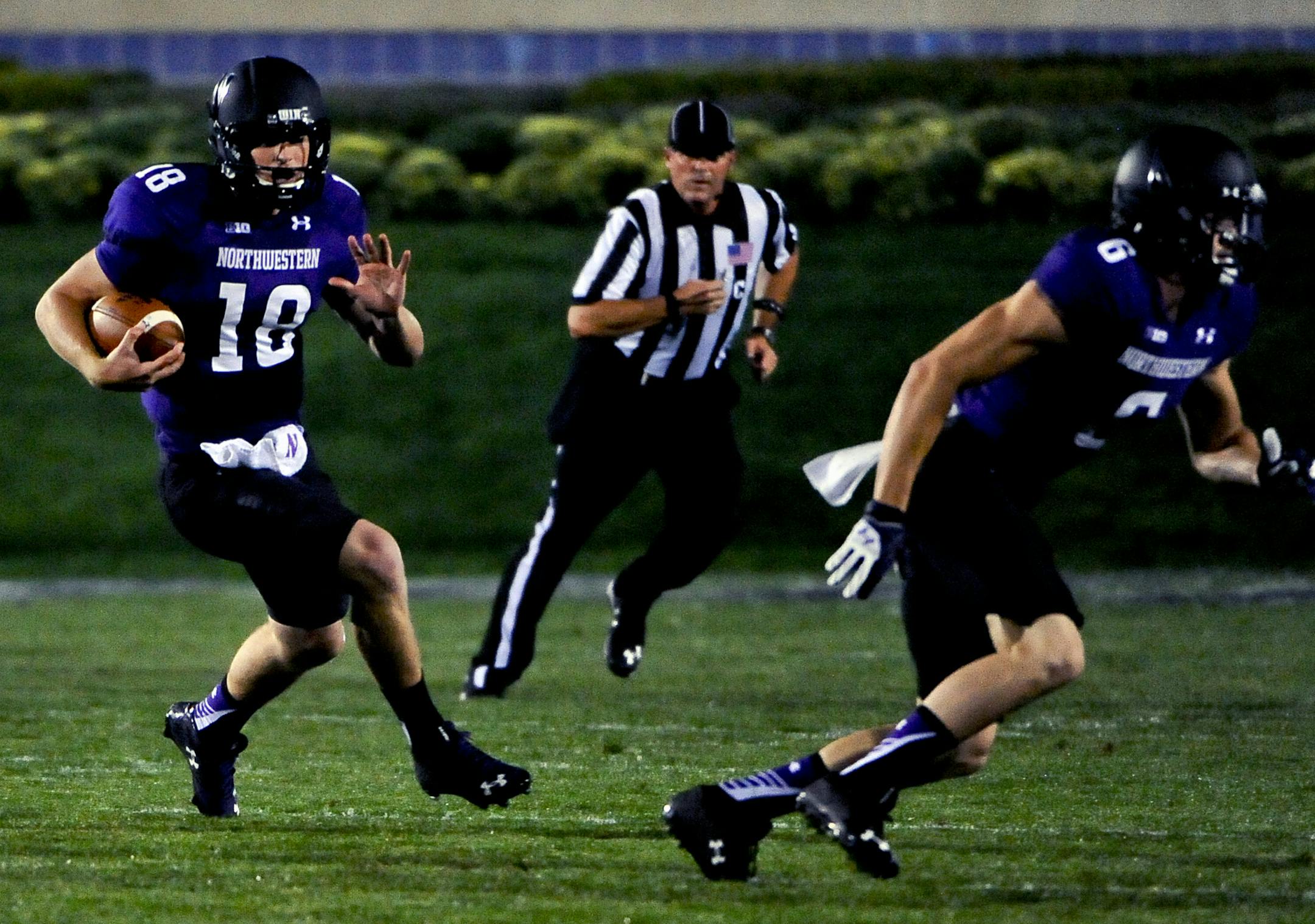 Northwestern quarterback Clayton Thorson (18) runs against Ball State earlier this season.