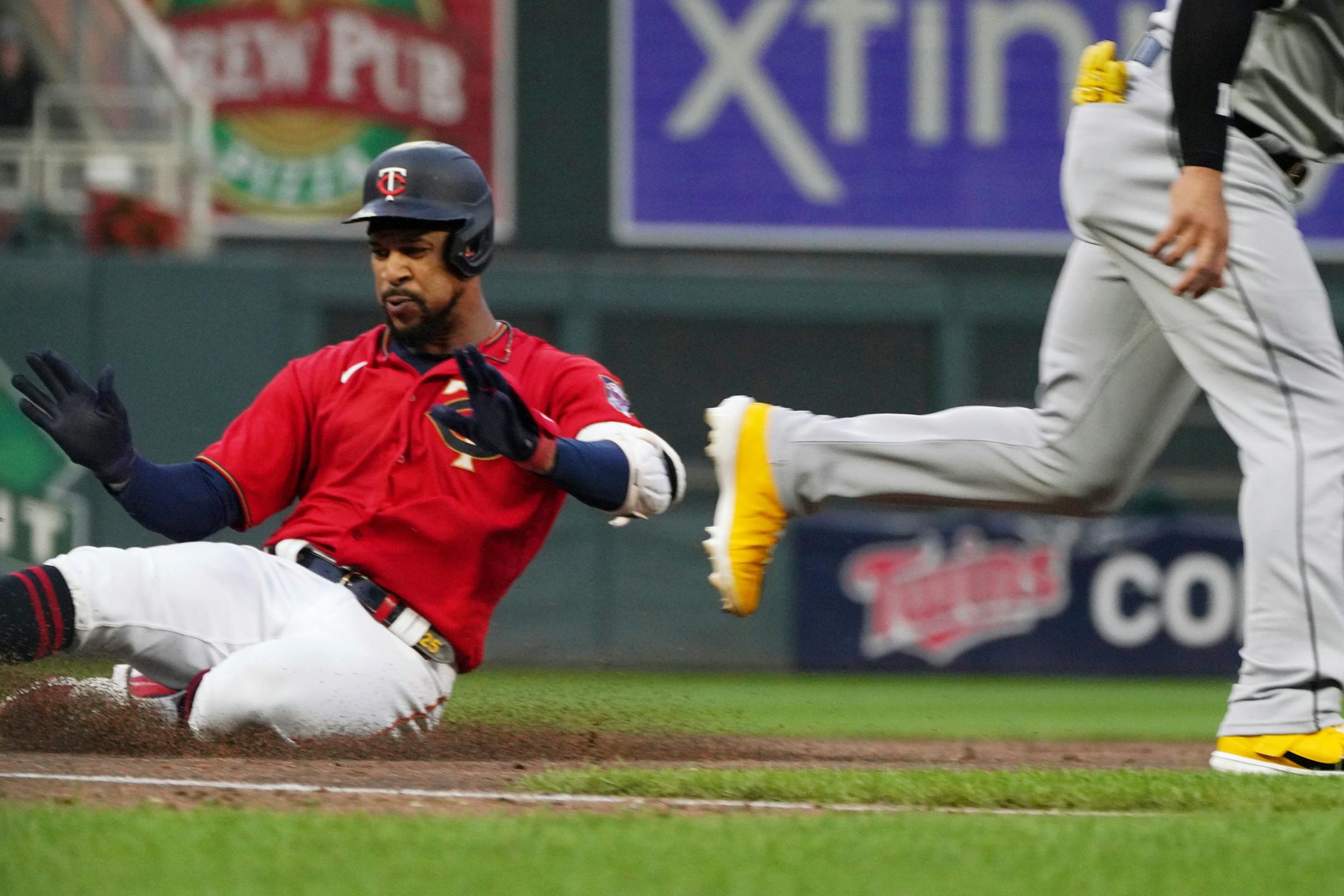 Minnesota Twins' Byron Buxton slides safely into third base on a triple off Chicago White Sox pitcher Johnny Cueto during the third inning of a baseball game, Thursday, July 14, 2022, in Minneapolis. (AP Photo/Jim Mone)