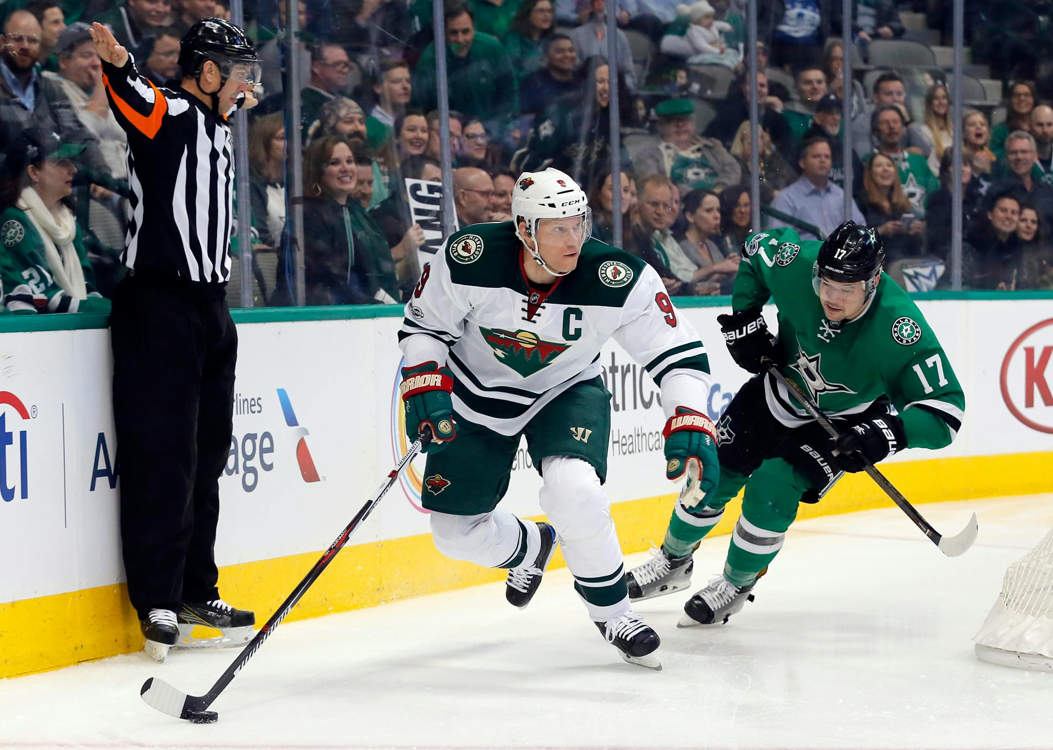Minnesota Wild's Mikko Koivu (9) of Finland moves the puck from behind the net as Dallas Stars' Devin Shore (17) gives chase in the first period of an NHL hockey game in Dallas, Tuesday Jan. 24, 2017. (AP Photo/Tony Gutierrez)