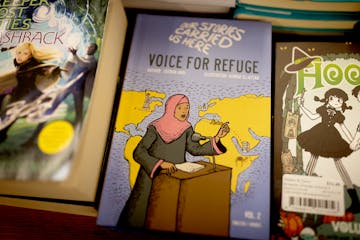 The book “Our Stories Carried Us Here — Voice for Refuge” sat in the youth book section at Magers & Quinn Booksellers in Minneapolis on Friday.