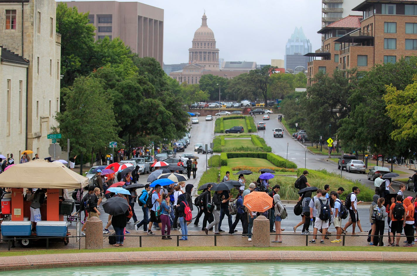 Students line sidewalks at the University of Texas campus in Austin, Texas, after buildings were evacuated after threates on Friday, September 14, 2012.