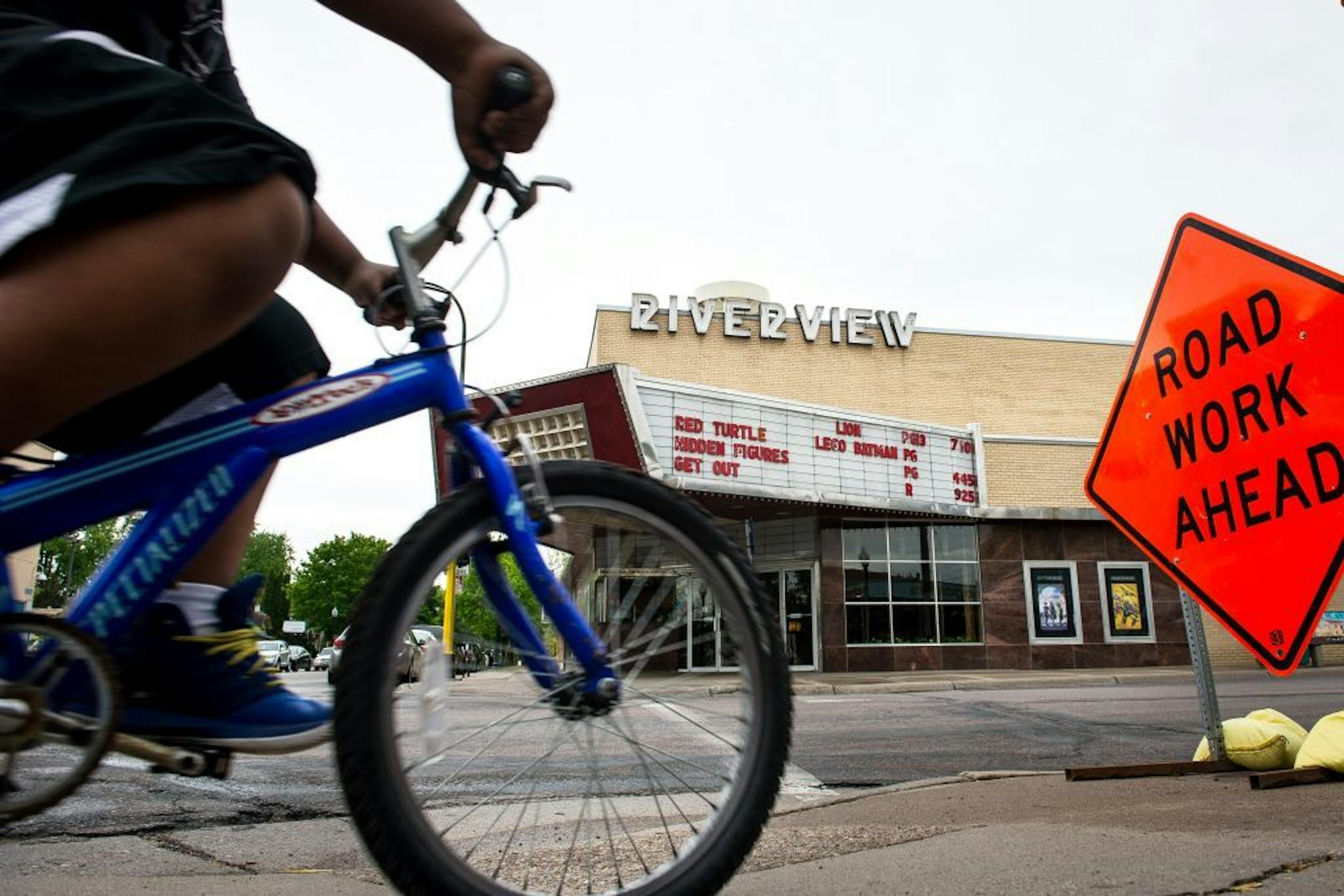 A young cyclist rode past the Riverview Theater Wednesday afternoon in Minneapolis.