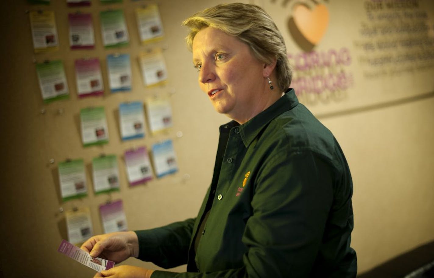 Sona Mehring, founder and executive director Caring Bridge read some of the stories of families touched by Caring Bridge. These are displayed on cards in their Eagan headquarters lobby. Tuesday, June 19, 2012