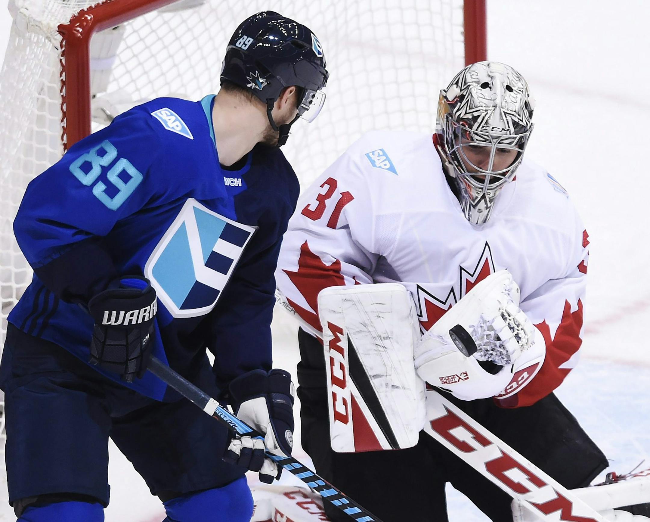 Canada goalie Carey Price (31) makes a save in front of Europe's Mikkel Boedker (89) during the second period of Game 2 of the World Cup of Hockey finals, in Toronto on Thursday, Sept. 29, 2016. (Nathan Denette/The Canadian Press via AP)