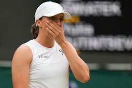 Iga Swiatek of Poland reacts during her third round loss to Yulia Putintseva of Kazakhstan at the Wimbledon tennis championships in London, Saturday, 