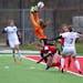 Eden Prairie's keeper Lindsay Eliasen makes a save on a free kick during the second half of the Class 2A girls' soccer state semifinals Tuesday, Octob