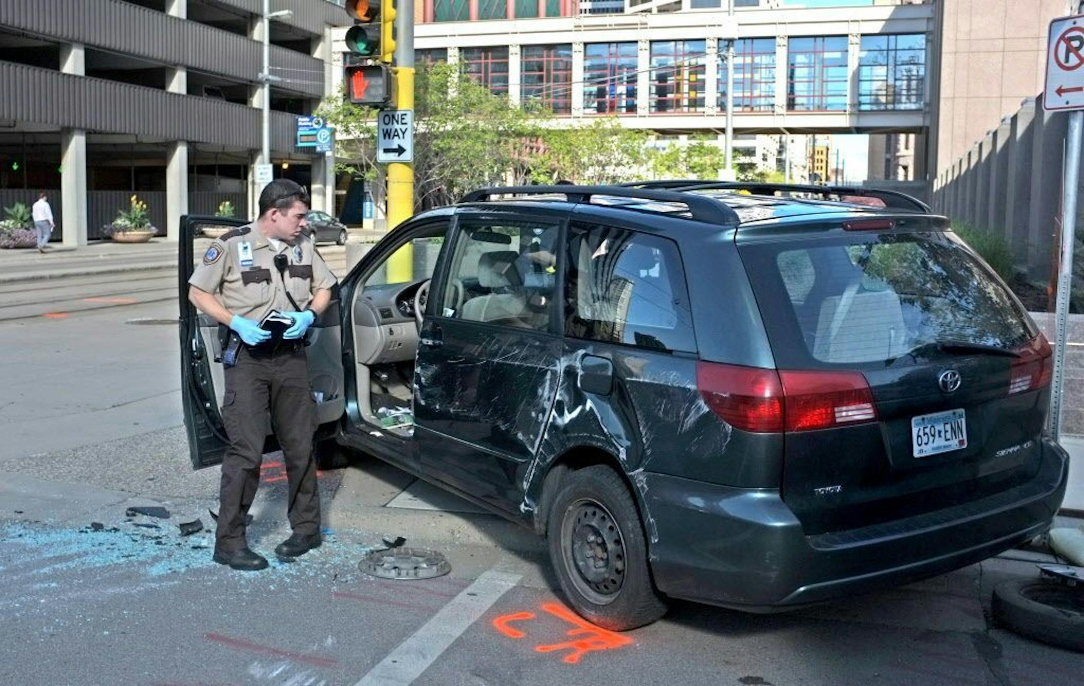 Emergency personnel check out a vehicle that collided with an light-rail train at 5th Street and 5th Avenue S. in Minneapolis Thursday morning.