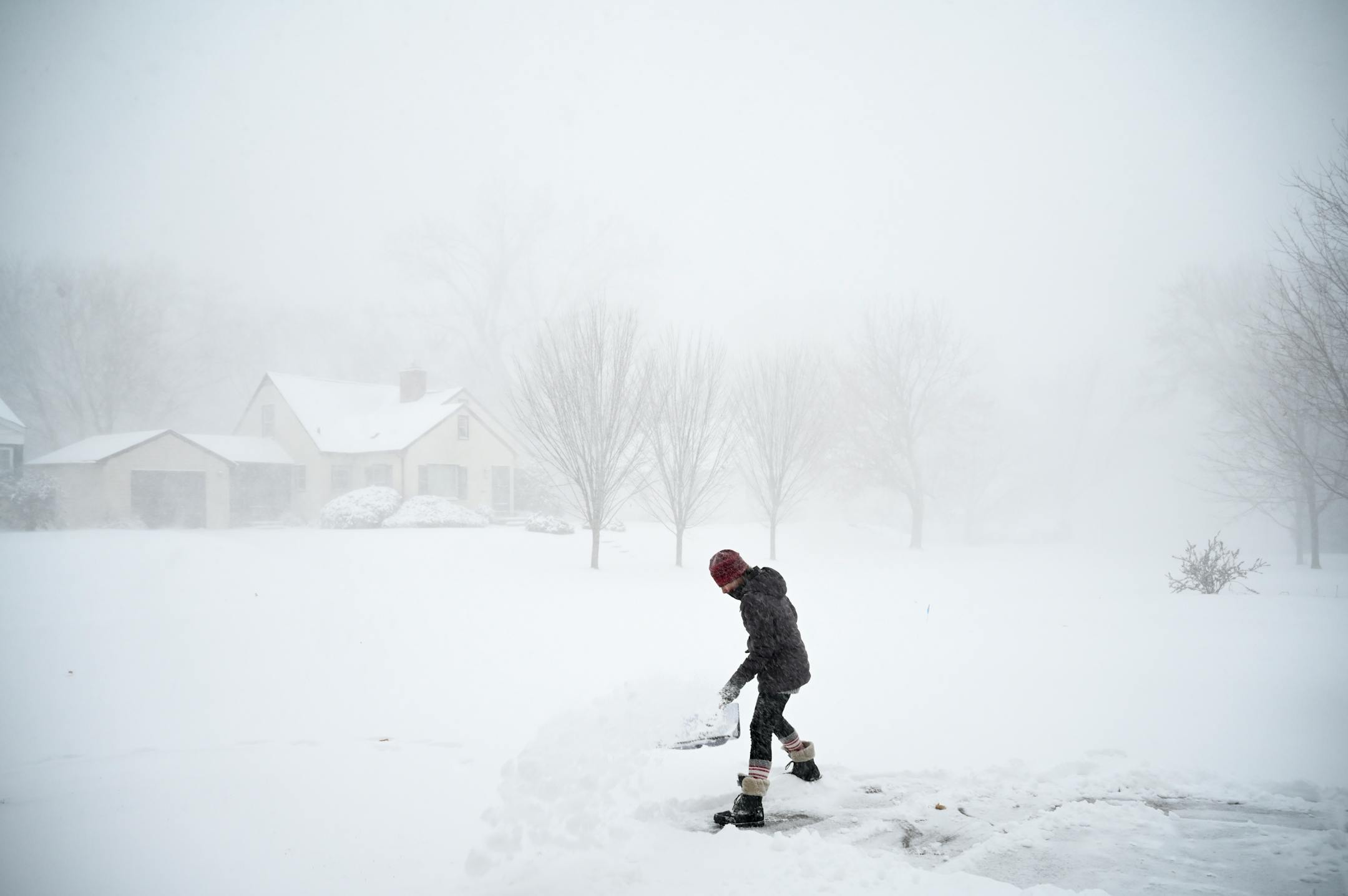 Camilla Cruz, a float nurse at North Memorial Health Hospital, shoveled her driveway Wednesday afternoon in Robbinsdale. The storm caught her off guard.