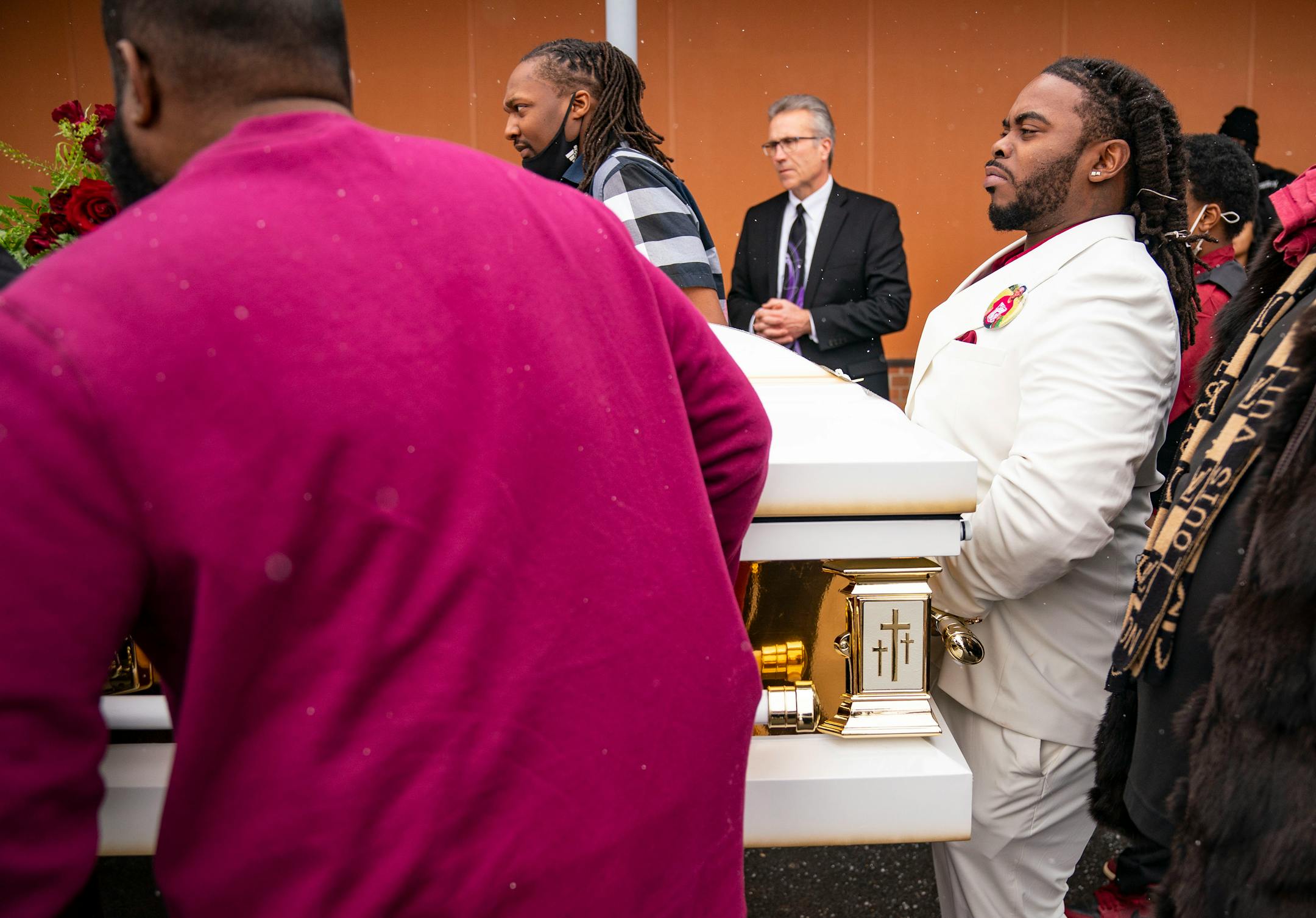 Cortez Rice, Jahmari Rice's father, helps carry his son's casket to the hearse after his funeral.