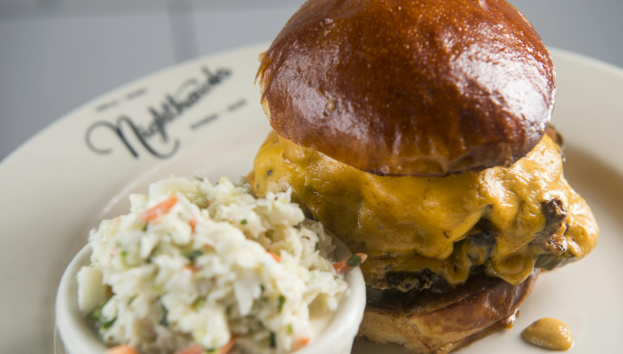The double cheeseburger with a side coleslaw at Nighthawks & Birdie located at 3753 Nicollet Ave, and created by chef/owner, Landon Schoenefeld. ] Isaac Hale ï isaac.hale@startribune.com This year's Taste Fifty focuses on Nicollet Avenue, also know as "Eat Street" in Minneapolis.