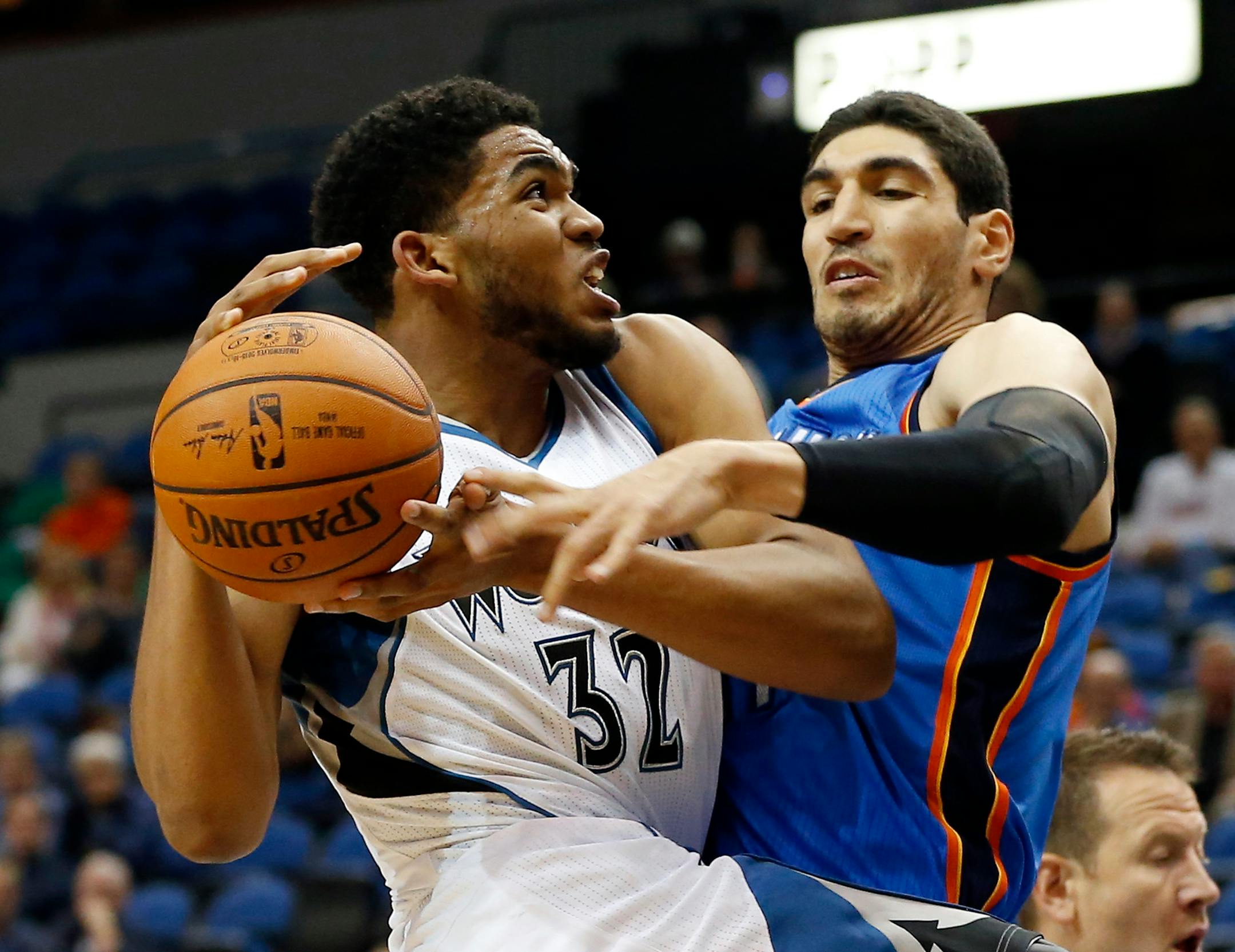 Minnesota Timberwolves� Karl-Anthony Towns, left, is fouled by Oklahoma City Thunder� Enes Kanter of Turkey in the first half of a preseason NBA basketball game, Wednesday, Oct. 7, 2015, in Minneapolis. Towns was the overall first round draft pick.(AP Photo/Jim Mone)
