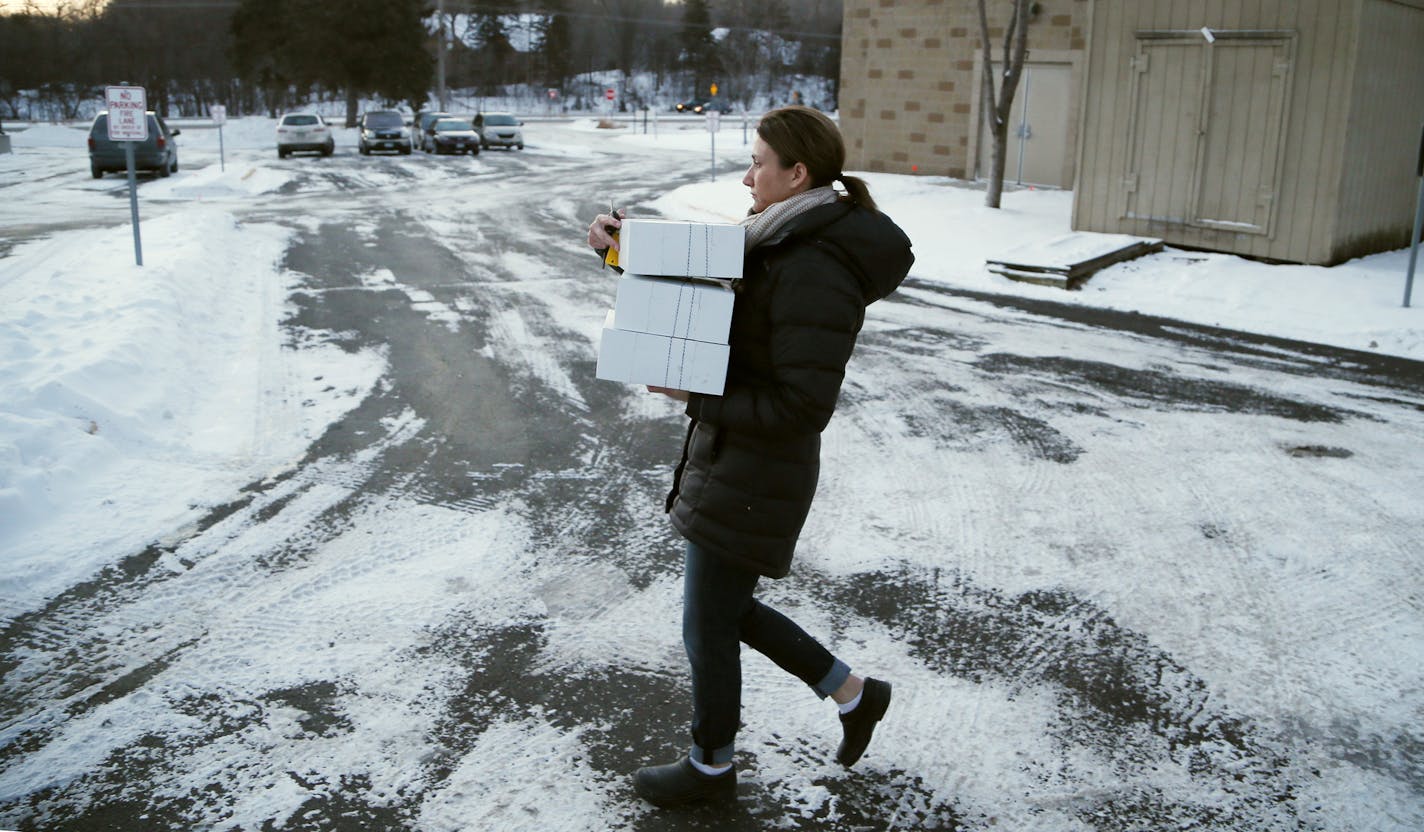 Tracy Kohler owner of Farina Bakeshop spent Wednesday morning carrying baking goods to her truck for a 9 am delivery to clients January 7, 2015 Excelsior, MN. ] Jerry Holt/ Jerry.Holt@Startribune.com