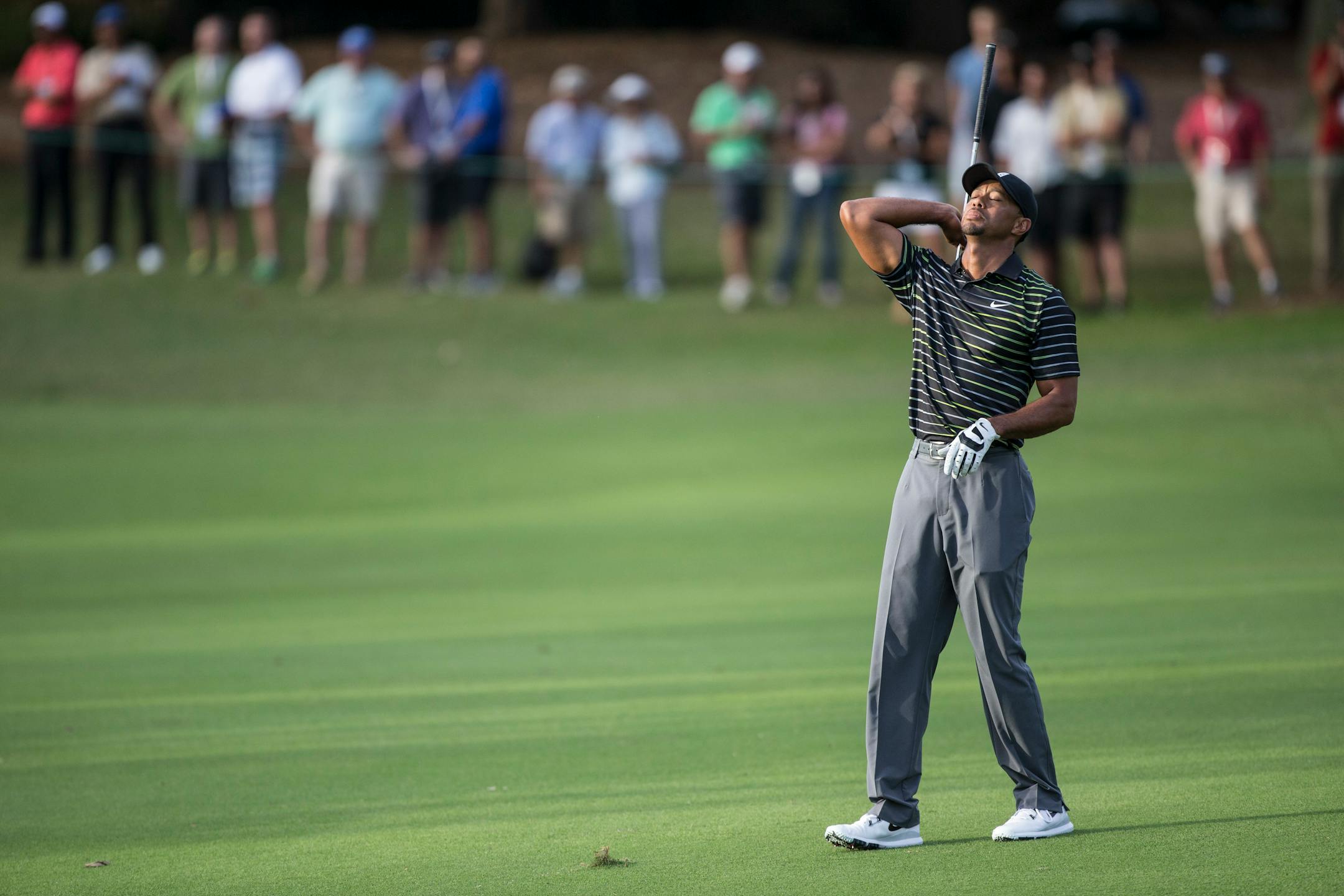 Tiger Woods shows his frustration after his last shot on the 18th fairway during the first round of the Hero World Challenge golf tournament on Thursday, Dec. 4, 2014, in Windermere, Fla. Woods finished the day in last place. (AP Photo/Willie J. Allen Jr.)