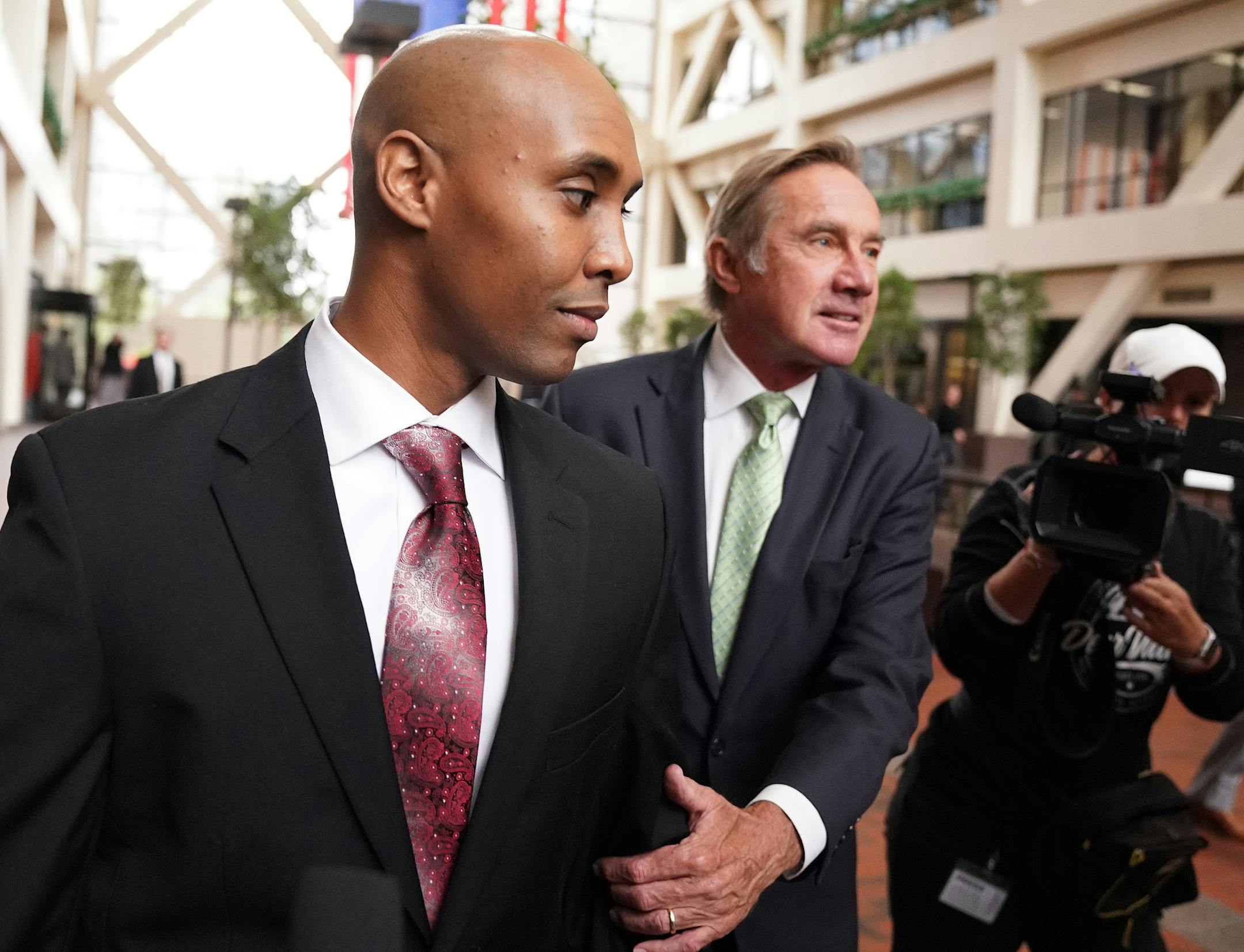 Mohamed Noor, accompanied by his legal team, Peter Wold, and Tom Plunkett left following a probable cause hearing for the ex-Minneapolis cop Thursday at the Hennepin County Government Center. ] ANTHONY SOUFFLE ï anthony.souffle@startribune.com Mohamed Noor, accompanied by his legal team, Peter Wold, and Tom Plunkett arrived to argue pretrial motions at a probable cause hearing for the ex-Minneapolis cop Thursday, Sept. 27, 2018 at the Hennepin County Government Center in Minneapolis. The he