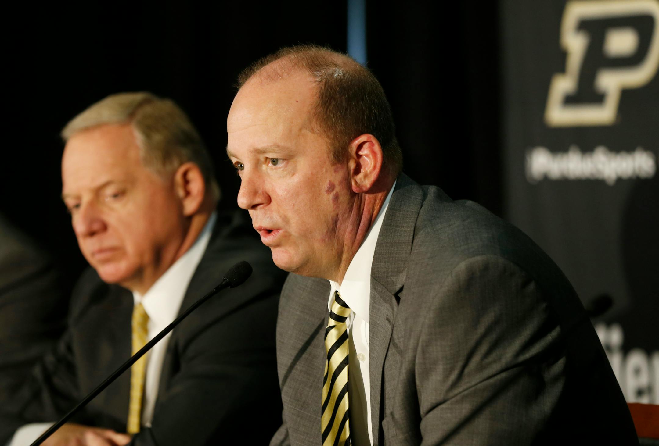 Jeff Brohm, right, addressed the media after being introduced as the new head football coach at Purdue in December. At left was Purdue athletic director Mike Bobinski.