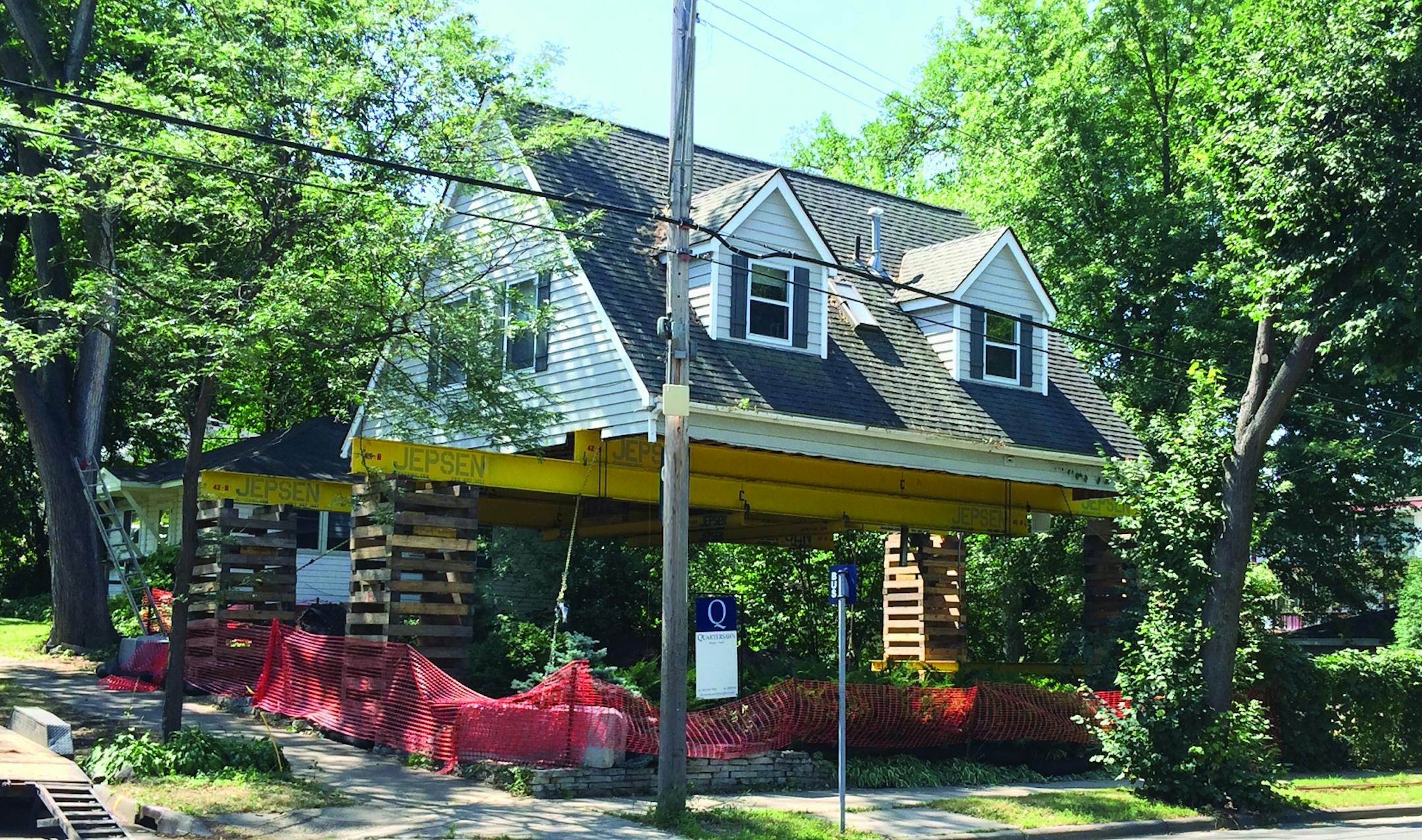 During the remodel, the home's second story was lifted on supports to allow construction of a new basement and main floor.