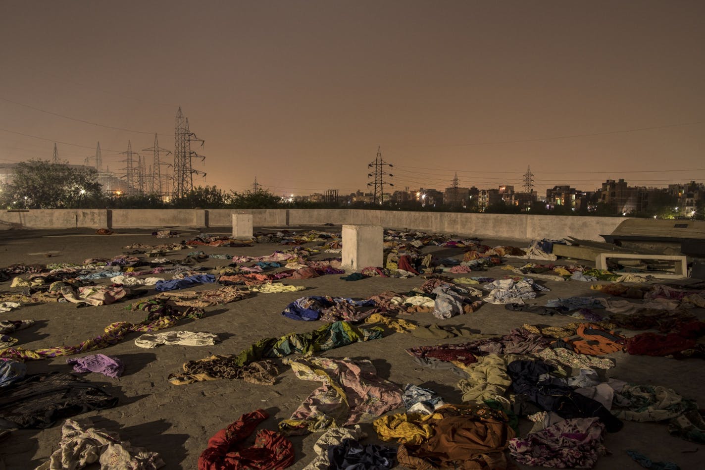 The discarded garments of people who died from Covid-19 on the rooftop of a crematorium in New Delhi, in April 2021. MUST CREDIT: Bloomberg photo by Anindito Mukherjee.