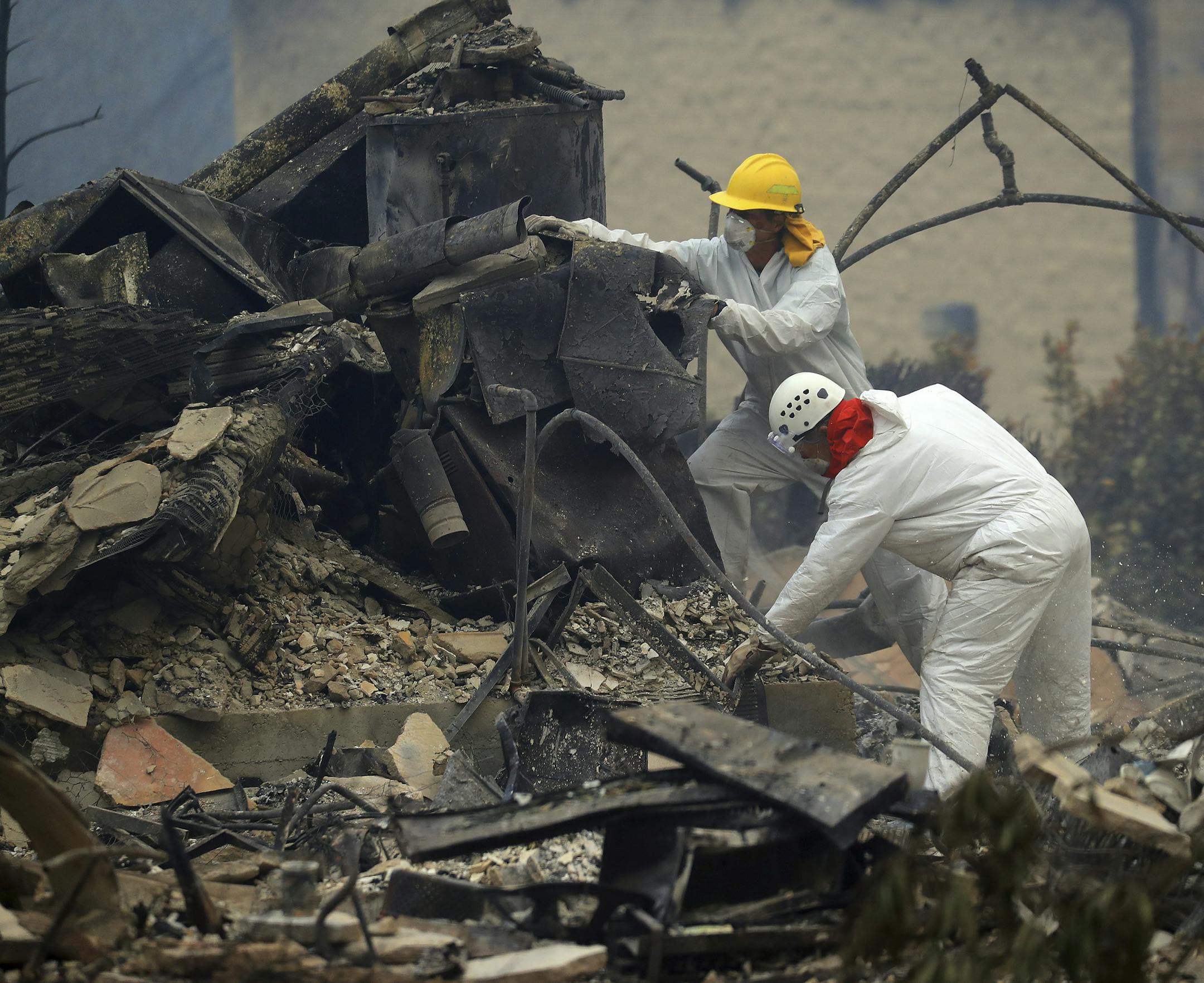 FILE -- Search and rescue team members search through debris of a structure looking for remains of missing people in Paradise, Calif., Nov. 13, 2018. The search of nearly 18,000 fire-ravaged structures has not settled the question of why nearly 200 people remain on the list of the missing.CreditCredit (Jim Wilson/The New York Times)