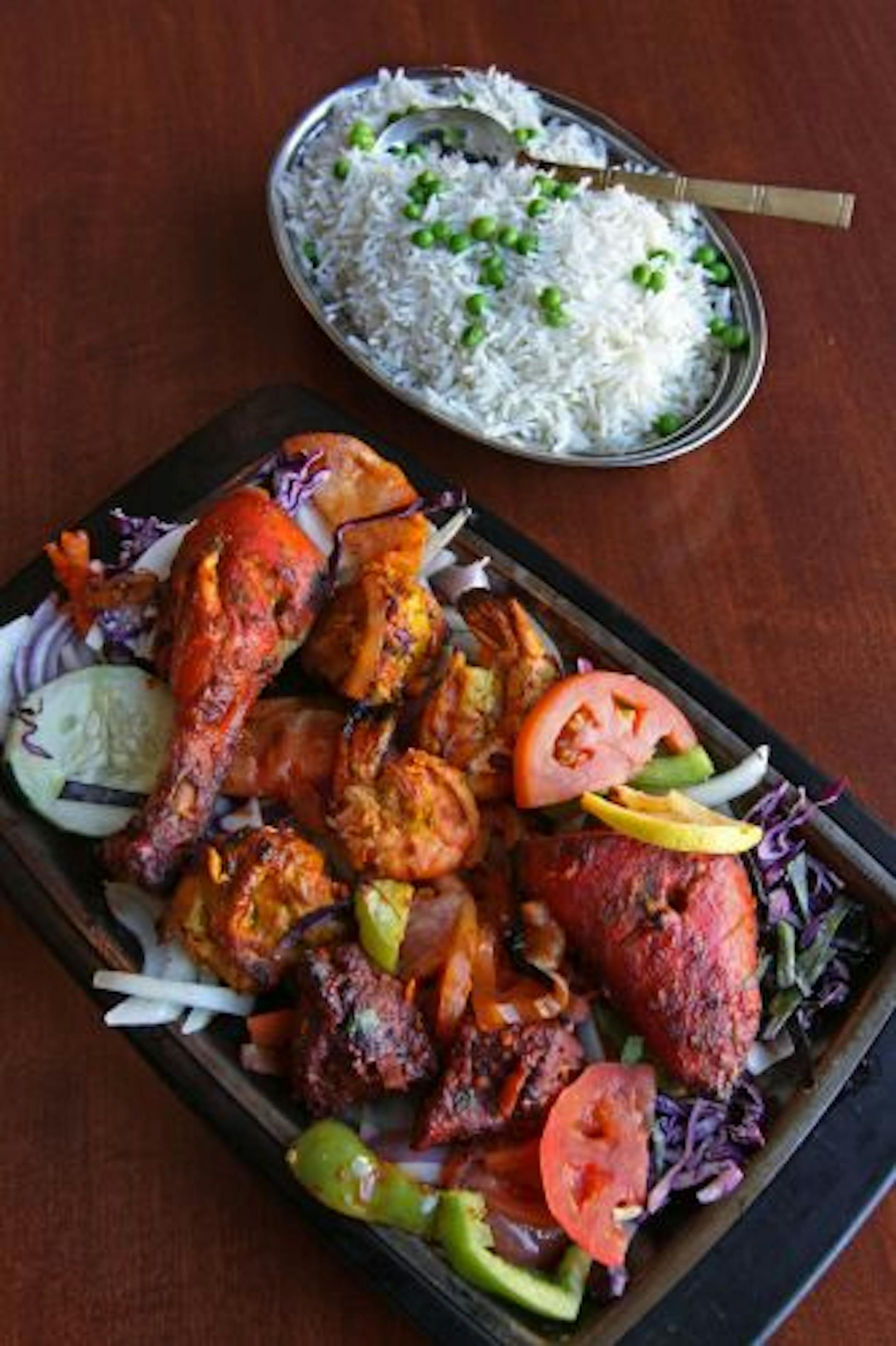 A crowd-pleasing platter features chicken, shrimp, lamb and rice at Darbar India Grill.