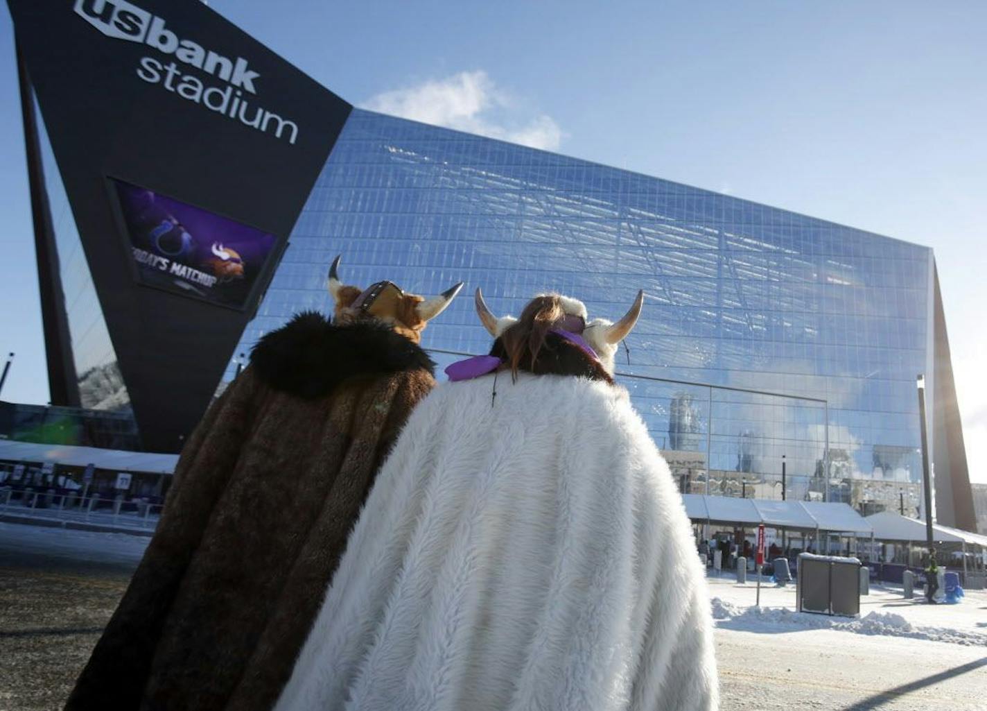 Fans bundled up for the cold weather head for U.S. Bank Stadium before the start of an NFL football game between the Indianapolis Colts and the Minnesota Vikings Sunday, Dec. 18, 2016, in Minneapolis.