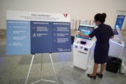 Amy Nelson disinfects a check-in kiosk after it was used by a passenger. Delta shows off its new cleanliness procedures at MSP. brian.peterson@startri