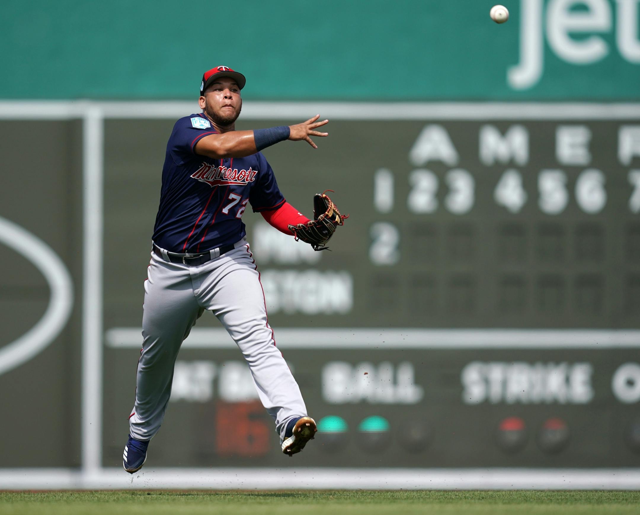 Minnesota Twins third baseman Randy Cesar (72) threw the ball to first to tag out Boston Red Sox left fielder Andrew Benintendi (16) during Sunday's game.