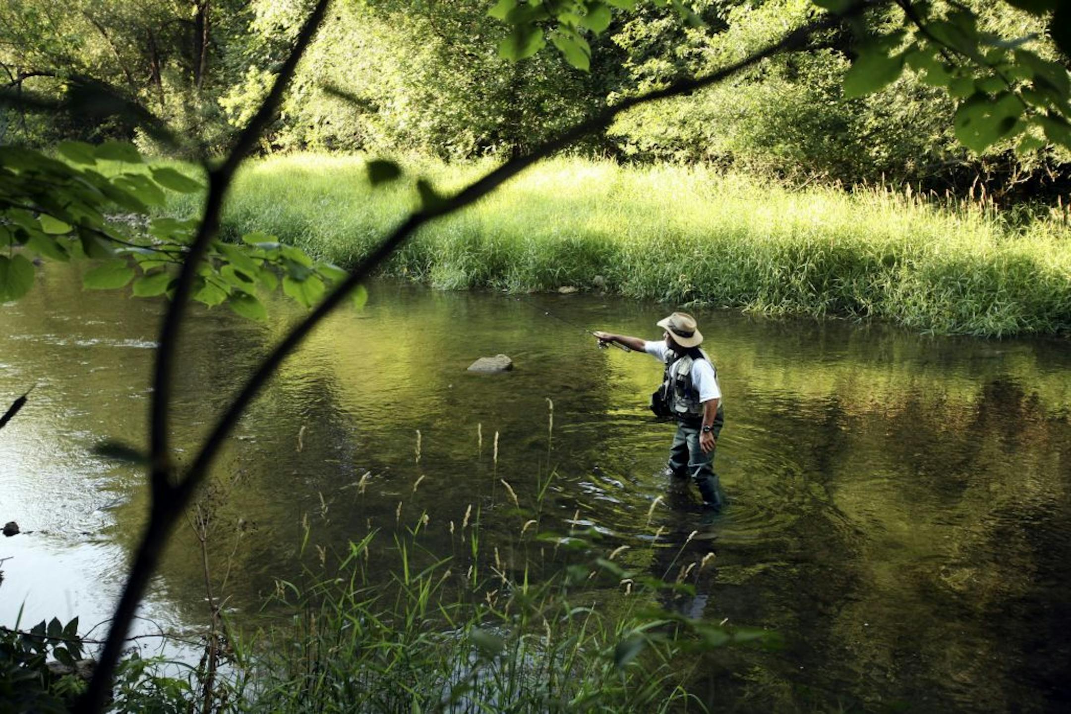 Majid Ahrar fishes for trout in the Whitewater River, which flows through Whitewater State Park near Elba, Minnesota. Ahrar was not aware that high pesticide levels have been found in the trout.