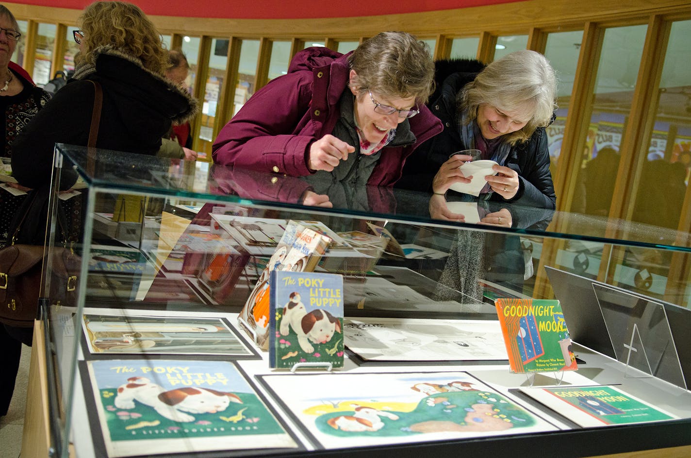 Visitors examine the original drawings for some of their most beloved children's books.