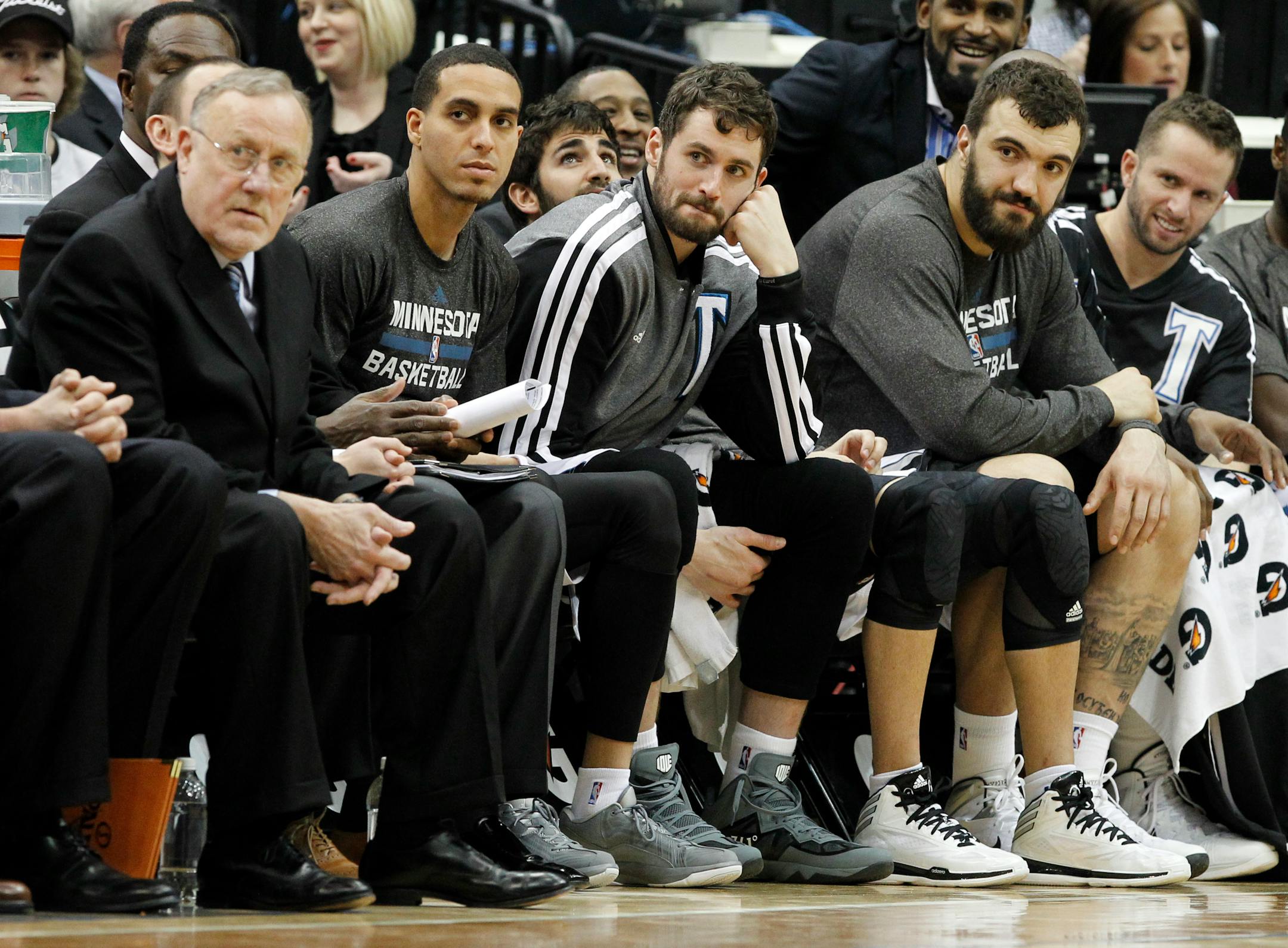 Minnesota coach Rick Adelman, left, guard Kevin Martin, second from left, forward Kevin Love, third from left, center Nikola Pekovic, and guard J.J. Barea, right, watch their teammates from the bench against the Los Angeles Lakers.