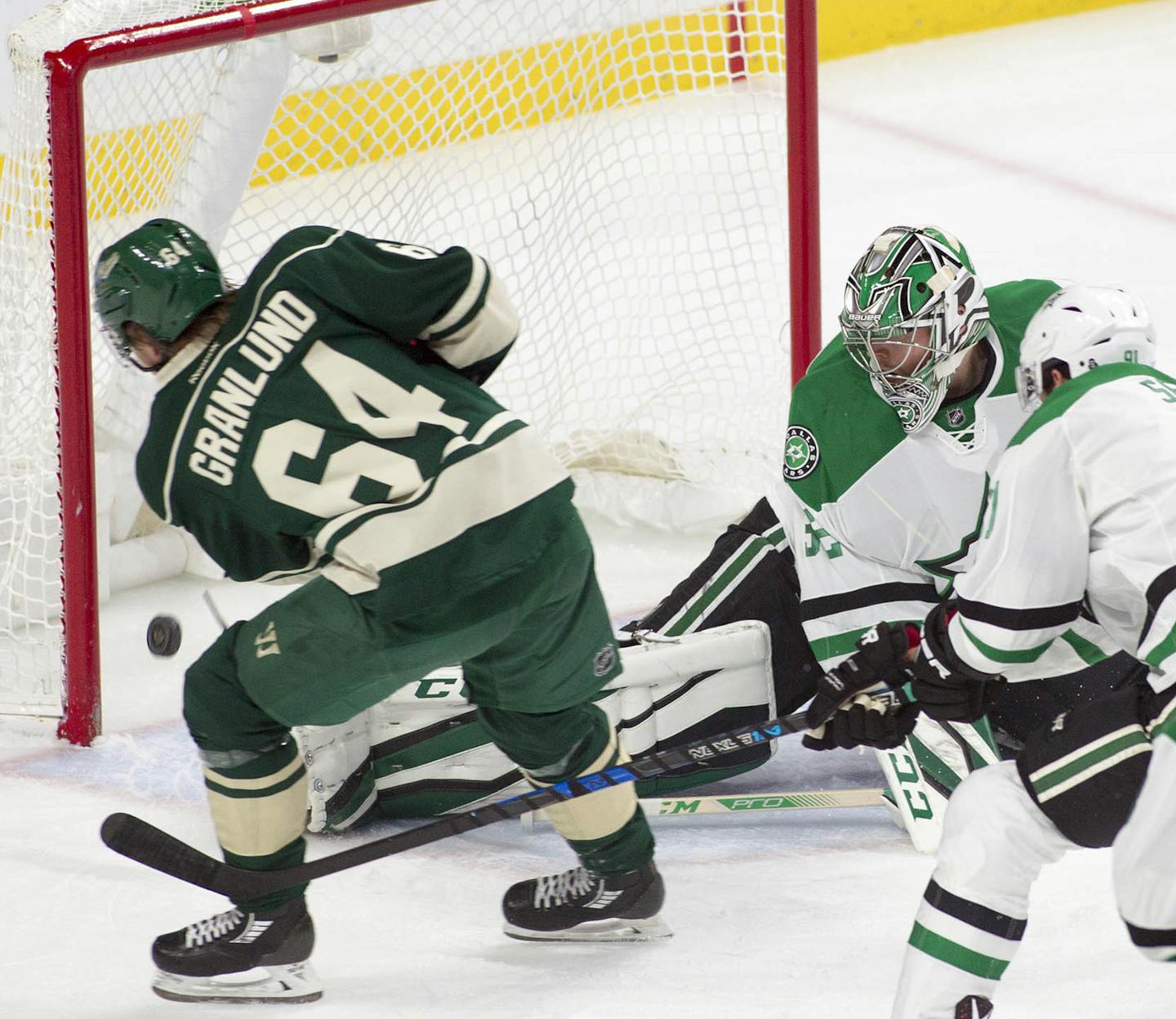 Minnesota Wild center Mikael Granlund, of Finland (64) scores a short-handed goal against Dallas Stars goalie Kari Lehtonen, of Finland (32) during the first period of an NHL game, Saturday, Oct. 29, 2016, in St. Paul, Minn. Dallas Stars center Tyler Seguin (91) defends on the play. (AP Photo/Paul Battaglia)