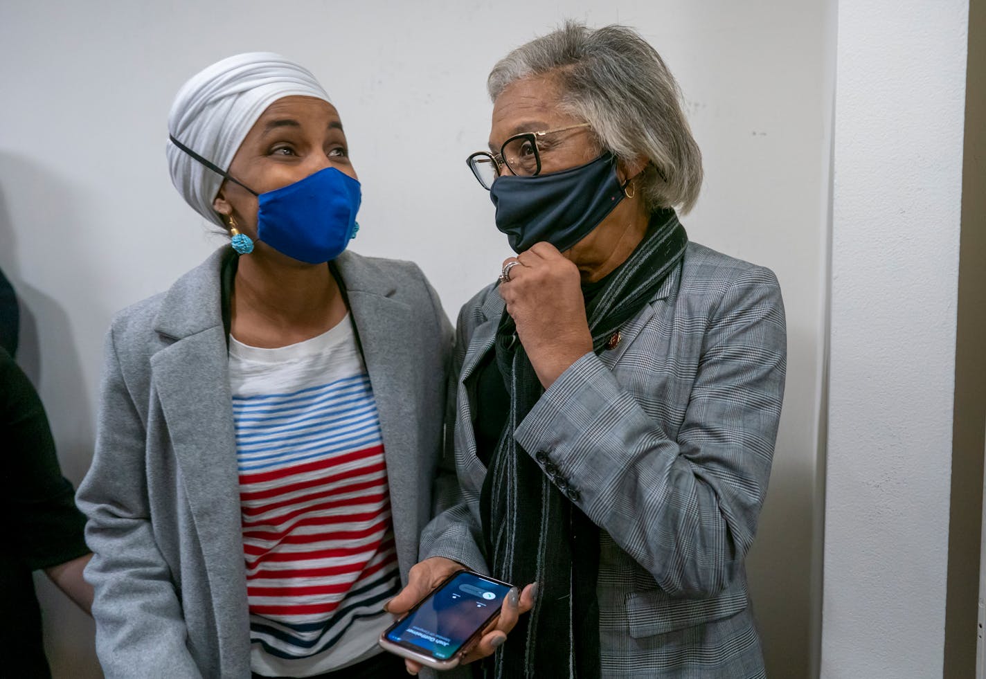 Rep. Ilhan Omar, D-Minn., a top member of the Congressional Progressive Caucus, left, speaks to Rep. Joyce Beatty, D-Ohio, chair of the Congressional Black Caucus, after Beatty was refused entry to a meeting with the Progressives, after the Democratic leadership abruptly postponed an expected House vote on a $1.85 trillion social and environment measure, at the Capitol in Washington, Friday, Nov. 5, 2021. (AP Photo/J. Scott Applewhite)