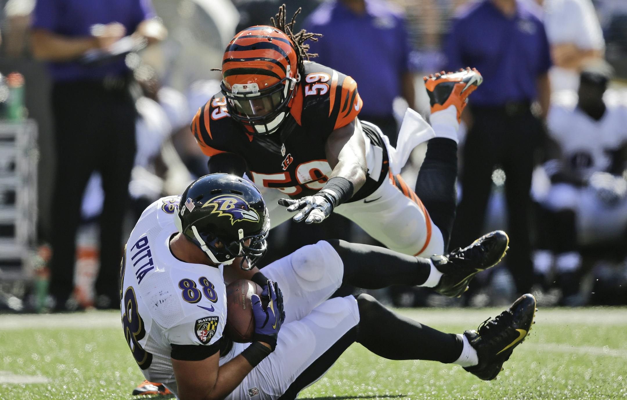 Cincinnati Bengals linebacker Emmanuel Lamur (59) leaps toward Baltimore Ravens tight end Dennis Pitta (88) during the second half of an NFL football game in Baltimore, Md., Sunday, Sept. 7, 2014. (AP Photo/Patrick Semansky) ORG XMIT: BAF121