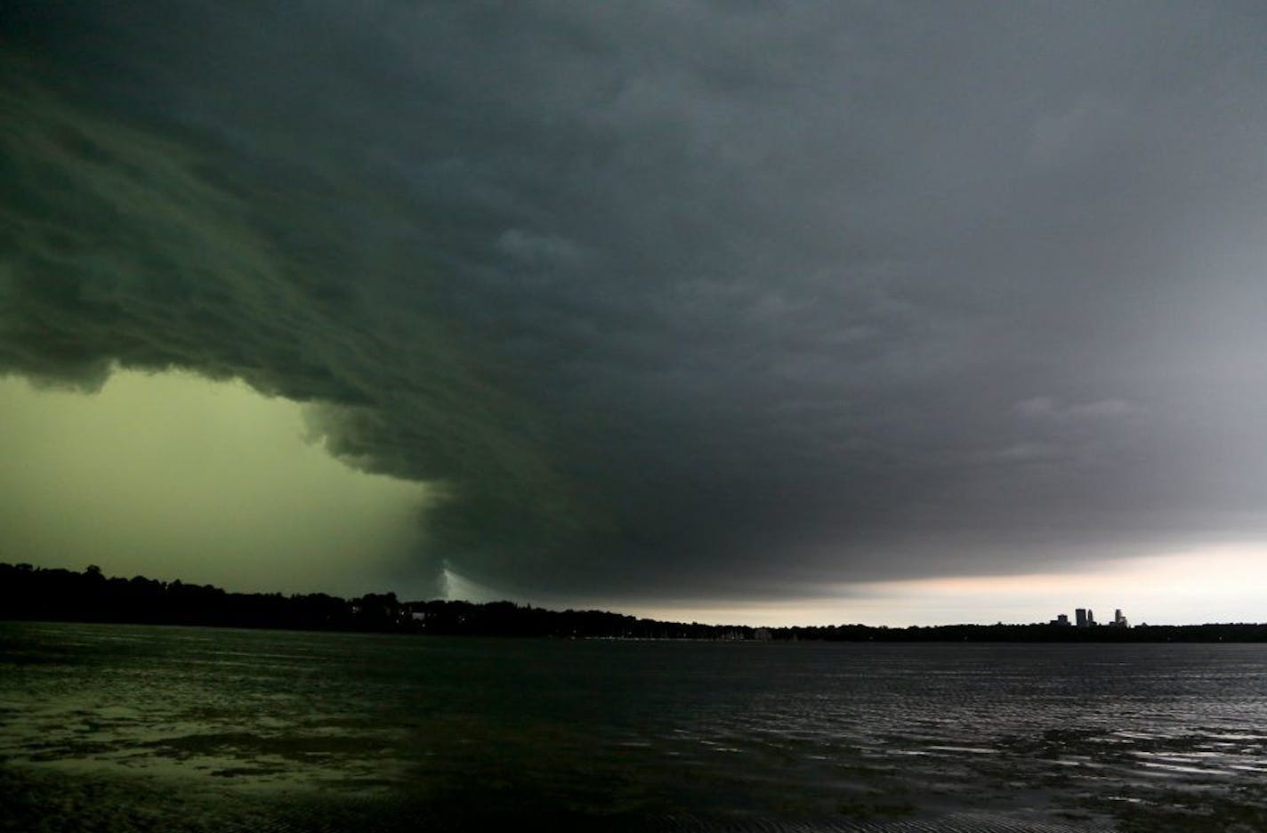 A severe thunderstorm rolls east towards downtown Minneapolis, lower right, seen from the south side of Lake Harriet Sunday, June 11, 2017, in Minneapolis, MN.