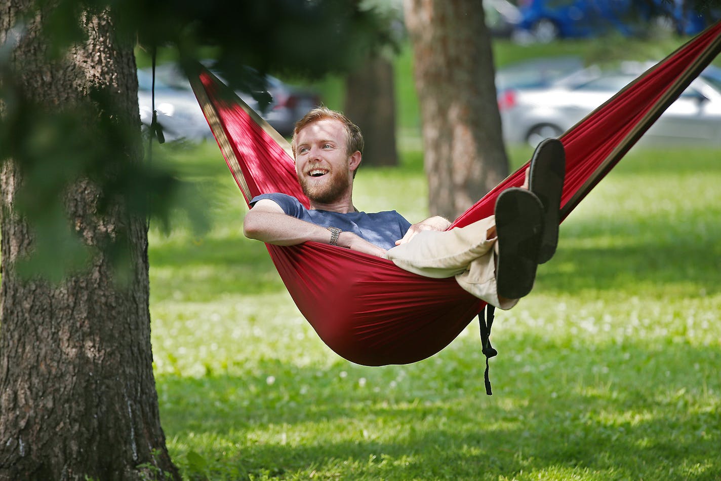 Benjamin Davis cheered on his friend Saijen Weihe as she climbed a tree to hang her hammock at Washburn Fair Oaks Park.