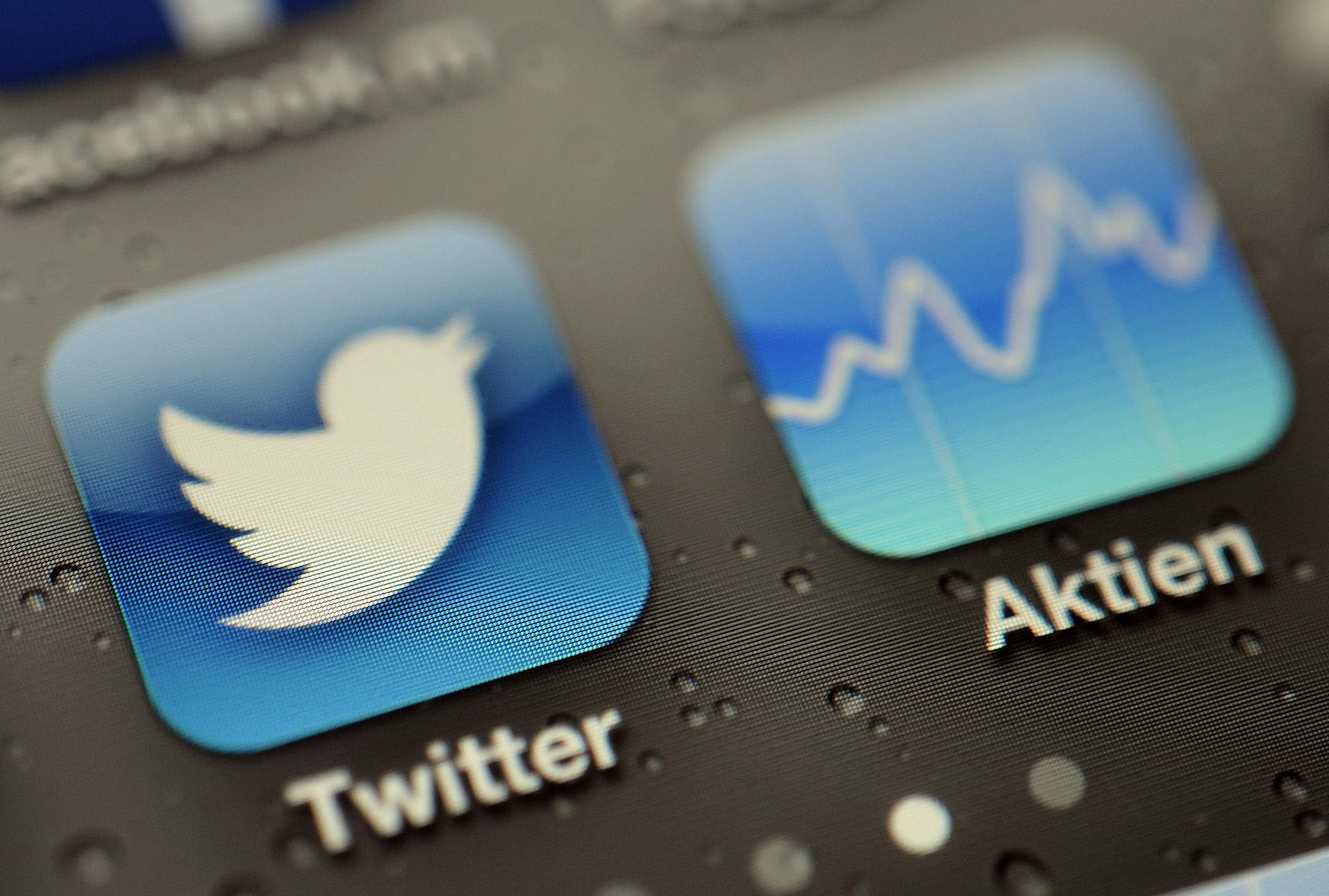 FILE - This Sept. 13, 2013, file photo shows a Twitter App and stock tracker on an iPhone, in Koln, Germany. Twitterís stock debut is the biggest coming-out party since Facebook, and Wall Streetís marquee exchanges are fighting to host it. (AP Photo/dpa, Marius Becker, File)
