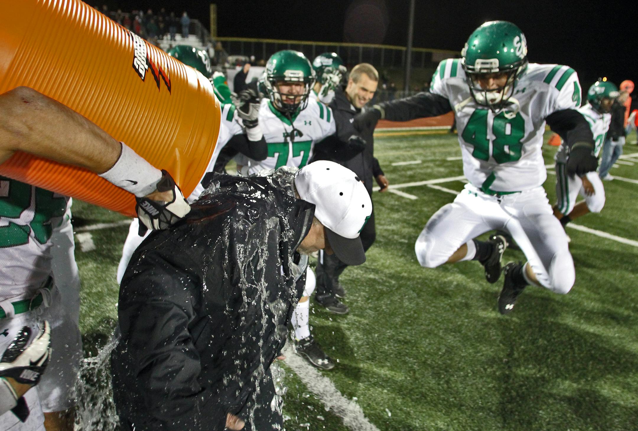 Prep football - Edina Hornets vs. Eden Prairie Eagles. Edina won 17-6. Edina head coach Reed Boltman was douced with Gator-Aid by players at the end of the game as Alec Cook (48) jumped for joy. (MARLIN LEVISON/STARTRIBUNE(mlevison@startribune.com (cq all names programi ) ORG XMIT: MIN1210122144154485
