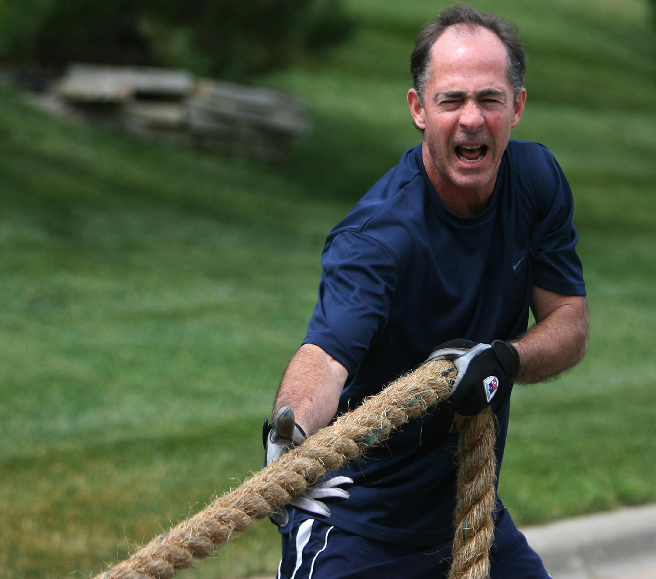 Jim Souhan attempted to pull rope, which was wrapped around the waist of former Vikings Mike Morris during a resistance training drill.