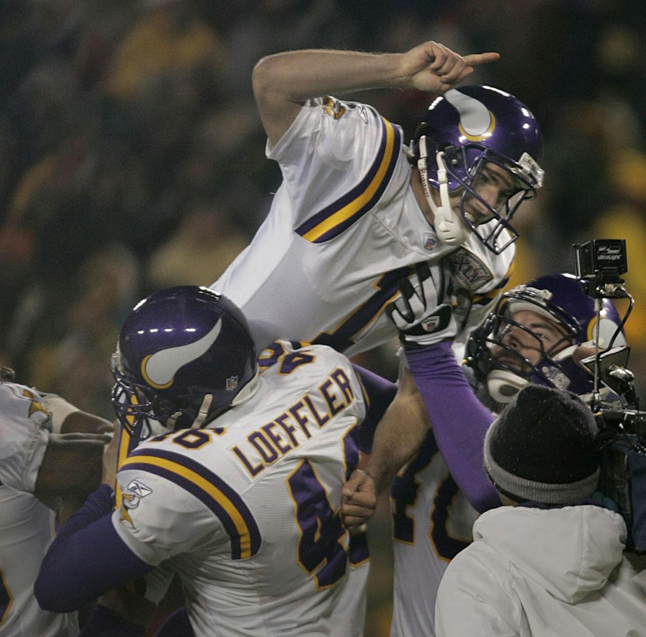 JIM GEHRZ � jgehrz@startribune.com Green Bay, WI/November 21, 2005/9:00PM Minnesota Vikings� Cullen Loeffler lifts kicker Paul Edinger on top of his shoulders after Edinger made the winning kick against the Green Bay Packers in NFL Monday, November 21, 2005 at Lambeau Field in Green Bay, WI. The final score was 20-17.