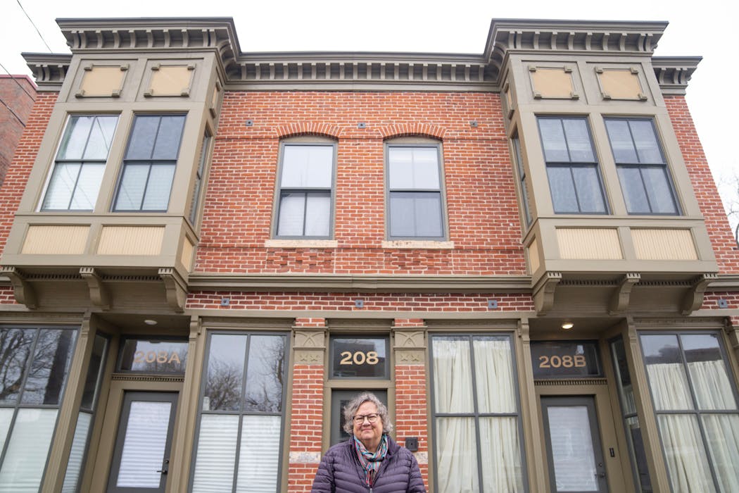 Carol Carey, the executive director at Historic St. Paul, outside a building from the 1880s that Carey helped preserve.