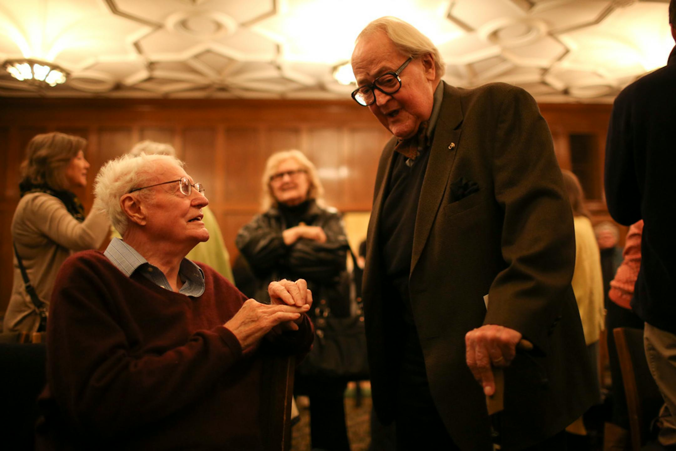 Dudley Riggs visited with Robert Bly, seated, after Bly's reading at the University Club on April 15, 2014.