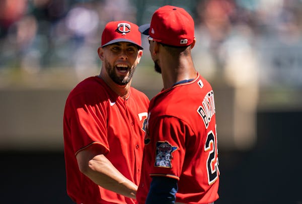 Minnesota Twins closer Jorge López, left, celebrates with Byron Buxton ,(25) after the last out against Detroit in Minneapolis.,Minn. on Wednesday Au