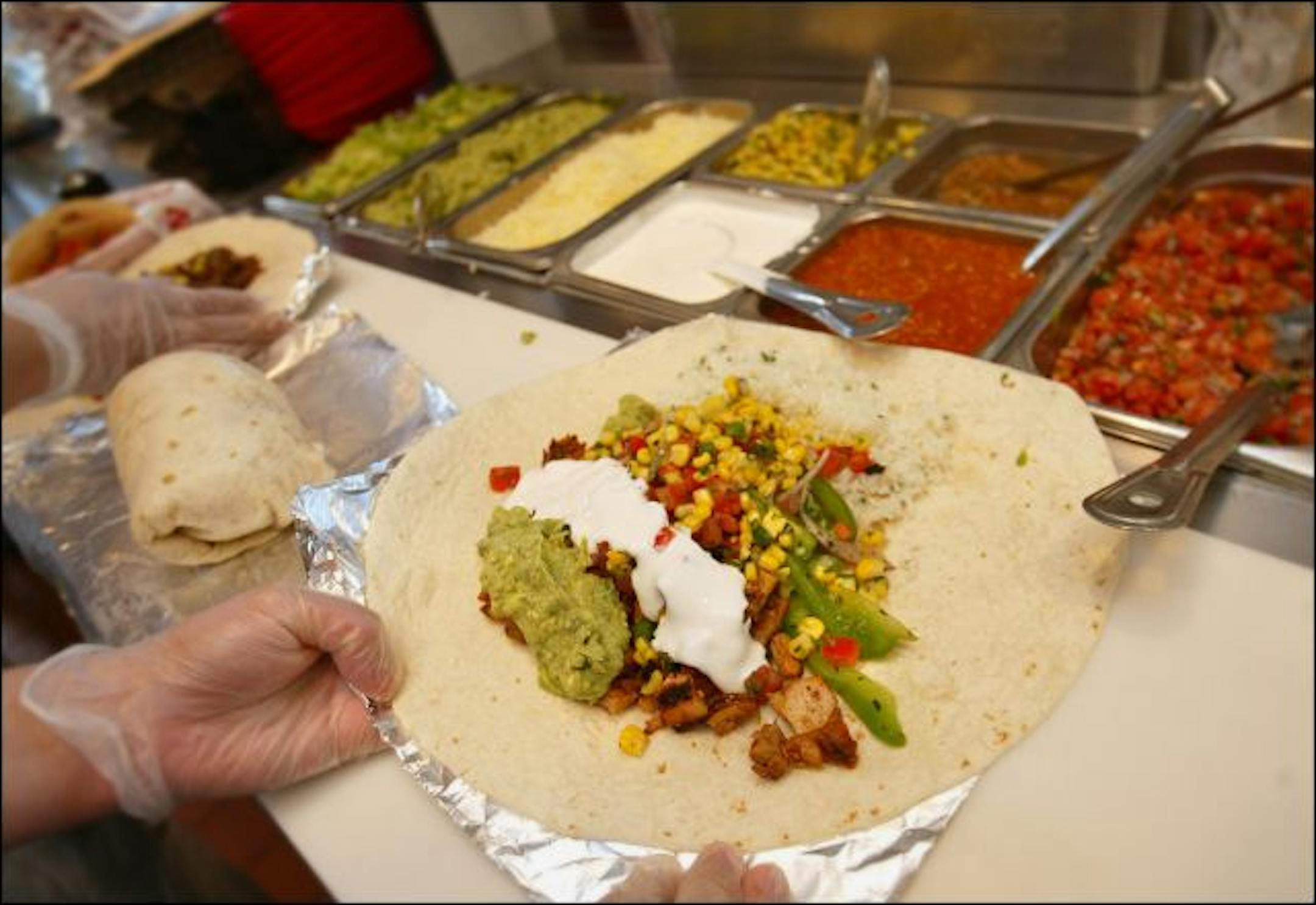 Chipotle Restaurant for photos, to go with the round-up story, on area mex style fast food. Giant Burritos are the hottest thing in fastfood these days, Chipotle, Qdoba Mexican Grill, Panchero's Mexican Grill and Baja Sol Tortilla Grill just to name a few places marketing the style. Chipotle's huge burrito at the Maple Grove location.