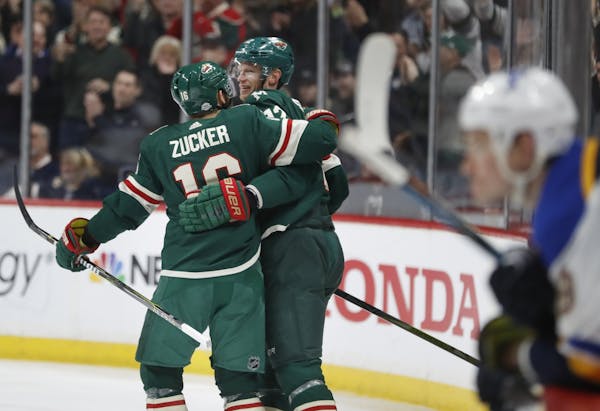 Jason Zucker(16) and Eric Staal(12) celebrate the Wild's 7th goal.