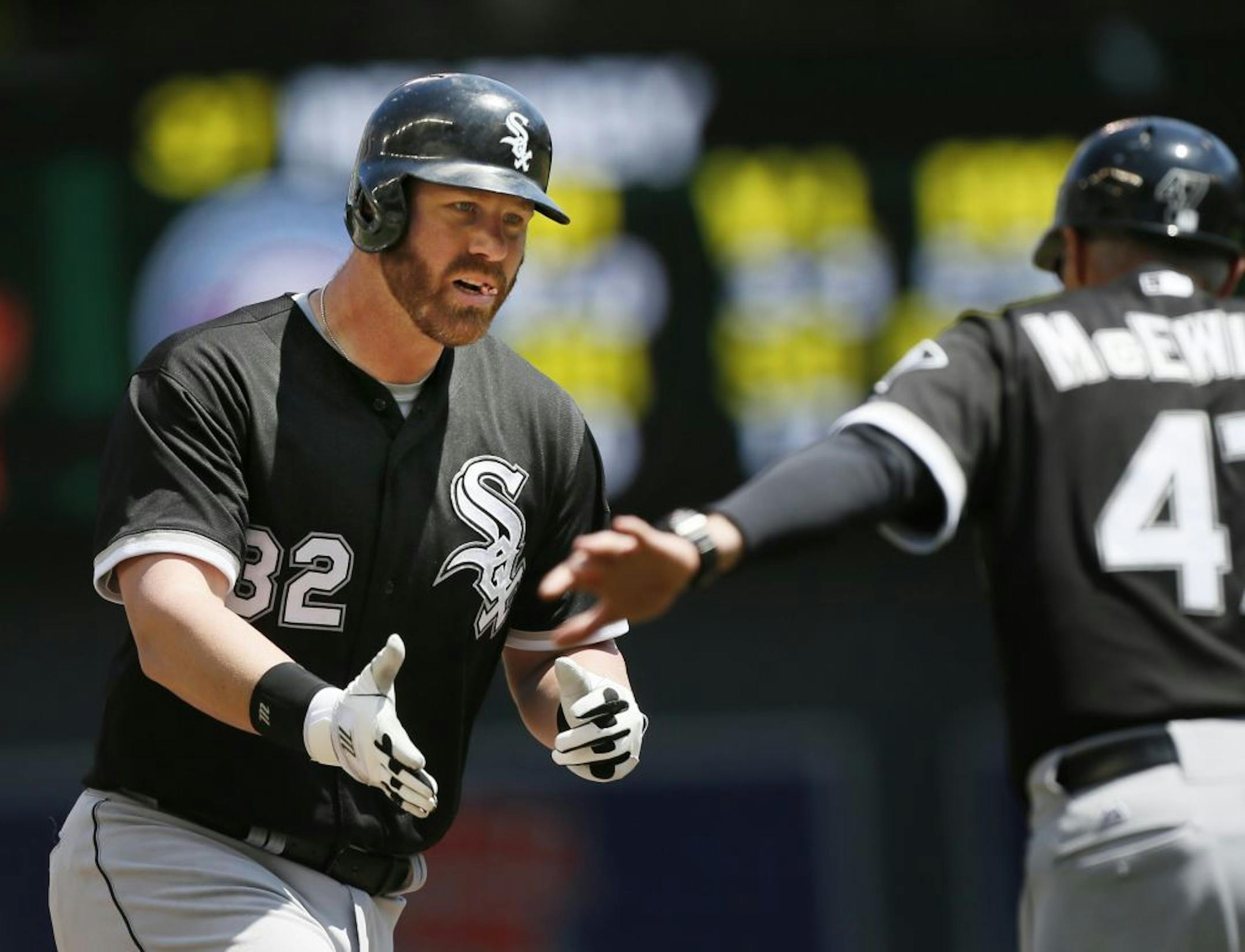 Adam Dunn rounds third after on a home run to left center. Alex Rios scores.