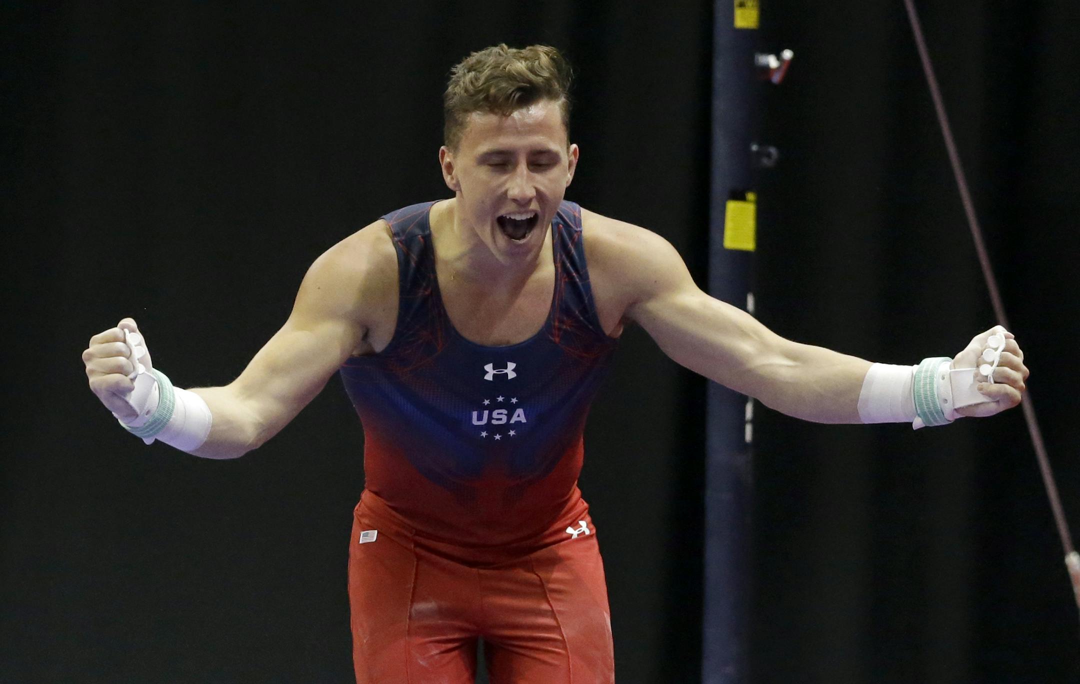 Eddie Penev celebrates after competing on the high bar during the U.S. men's Olympic gymnastics trials Saturday, June 25, 2016, in St. Louis. (AP Photo/Jeff Roberson)w